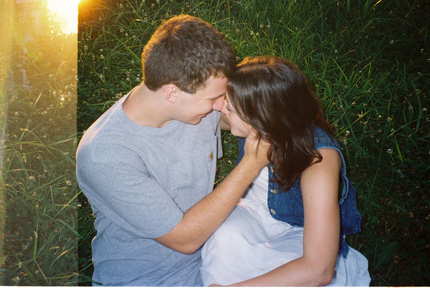 35mm film of young adventurous couple holding each other during sunset