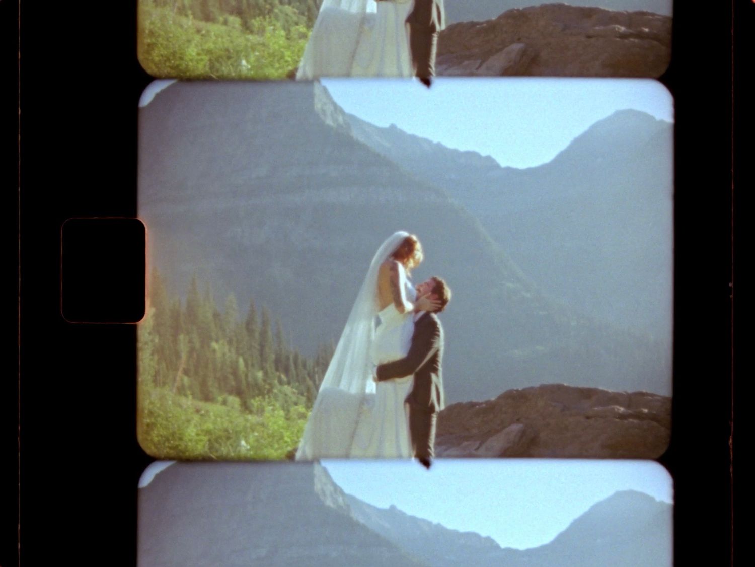 super 8 still of couple embracing in glacier national park at logan's pass