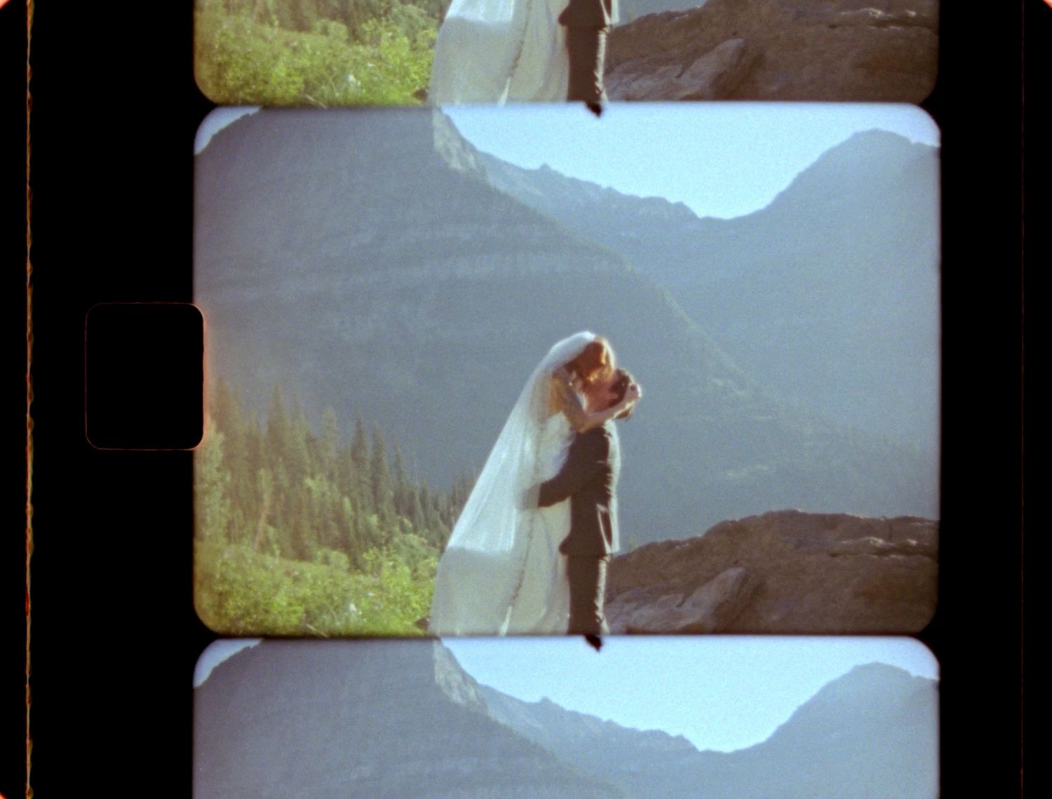 super 8 still of couple embracing in glacier national park at logan's pass