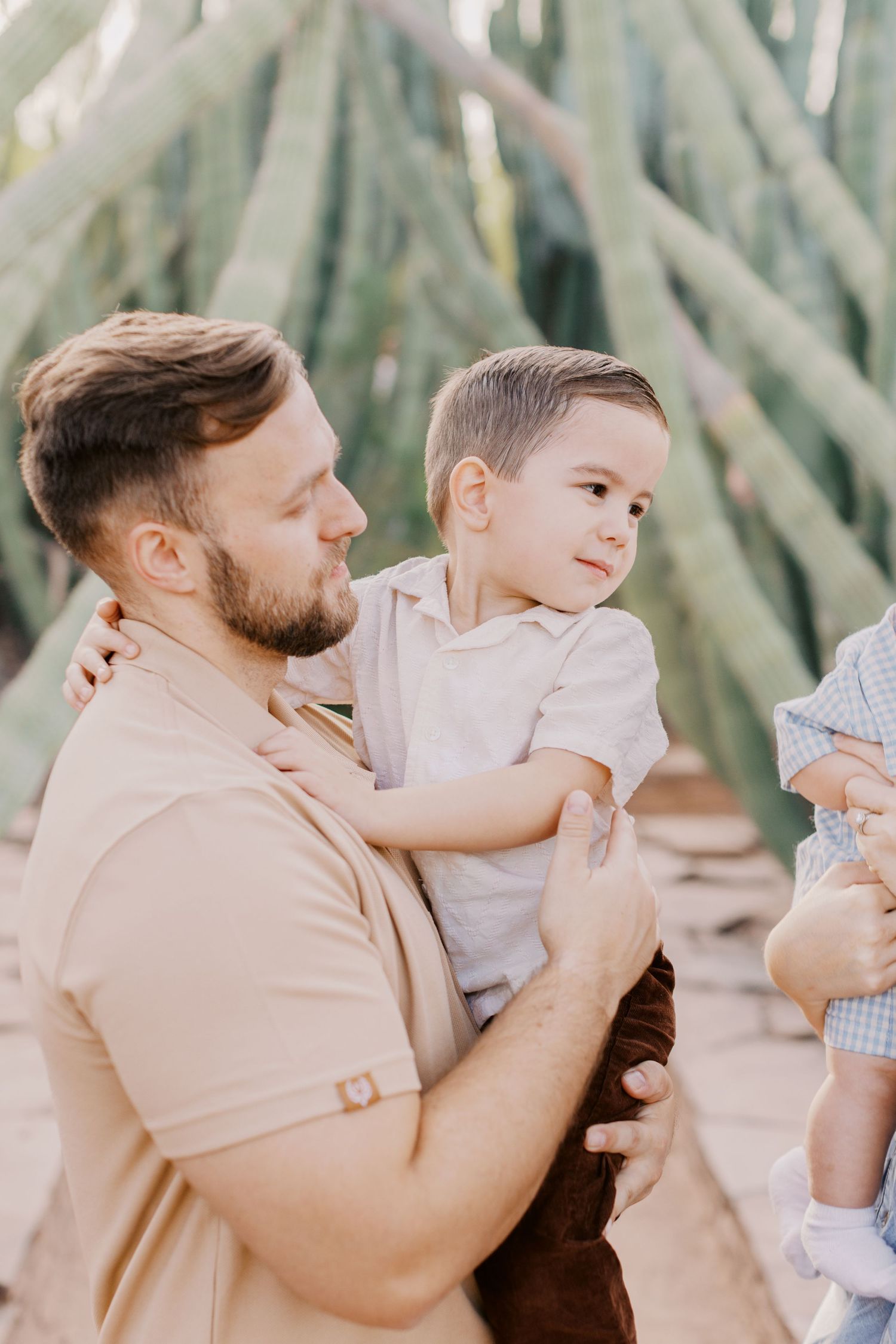 Candid moments between parent and child captured in a desert setting with soft lighting.