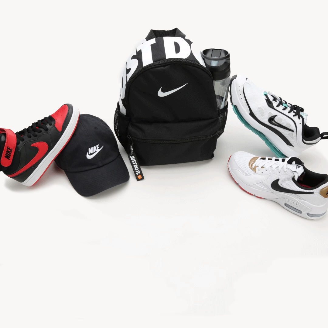 A collection of Nike athletic gear including black and white sneakers, a black cap, and a black backpack on white background.
