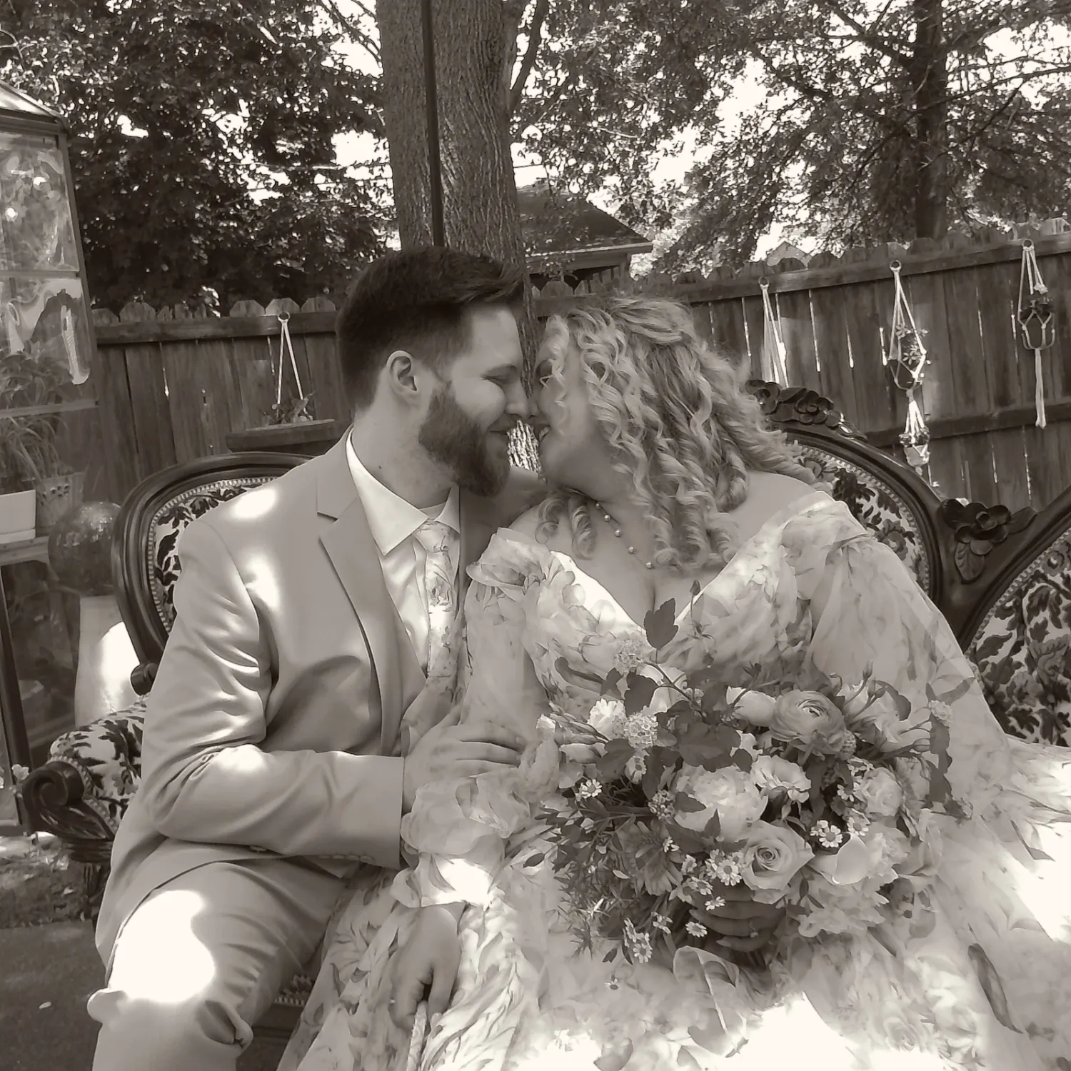 Romantic black and white photo series of a couple in wedding attire sharing intimate moments under trees.