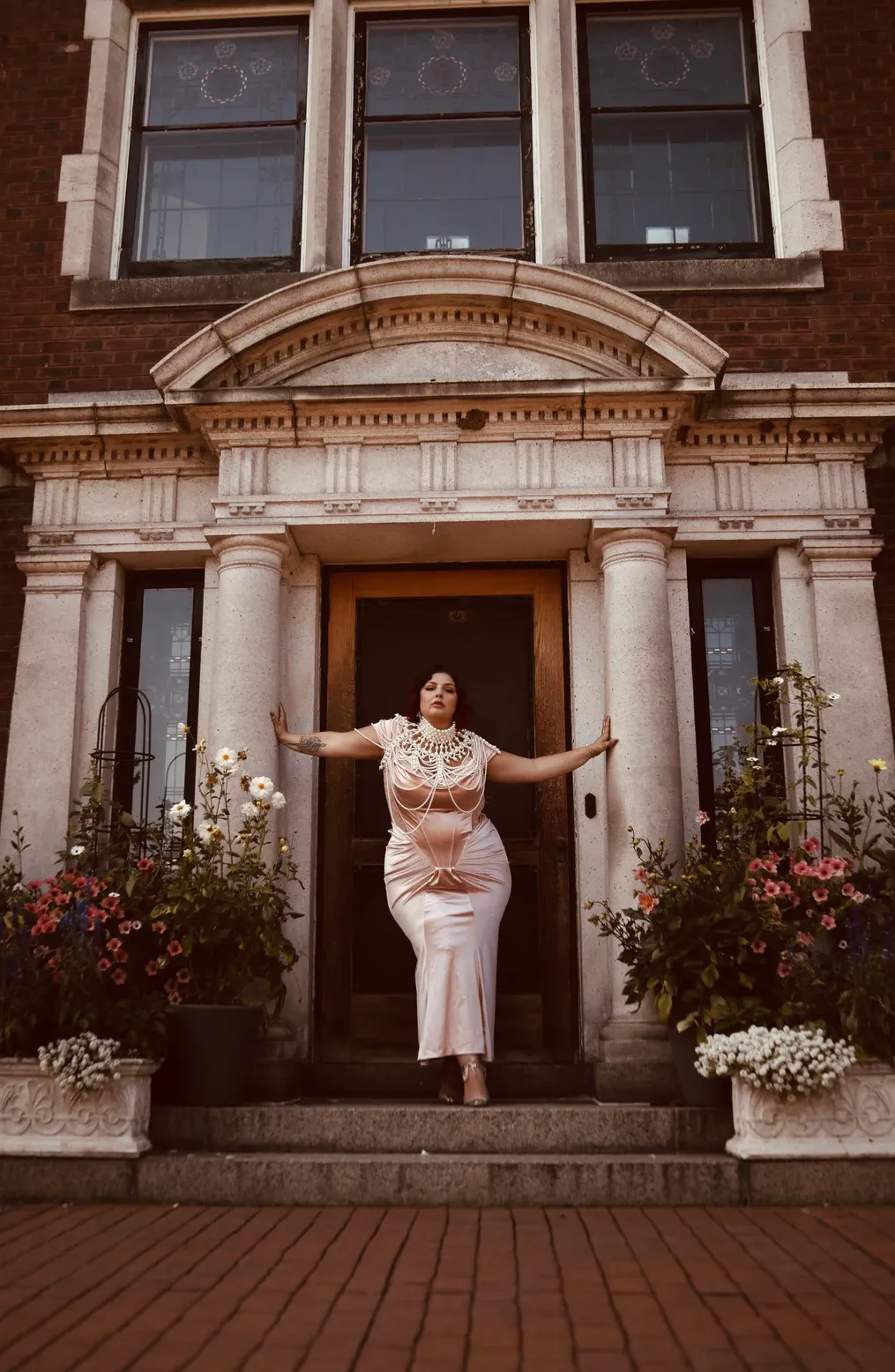 A series of four architectural photos showing a brick building exterior with columns and window boxes filled with flowers.