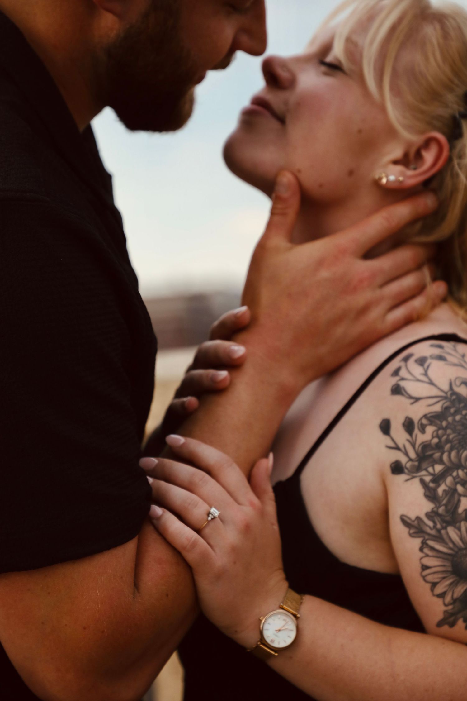 Intimate close-up shots of couple sharing tender moments by the water.