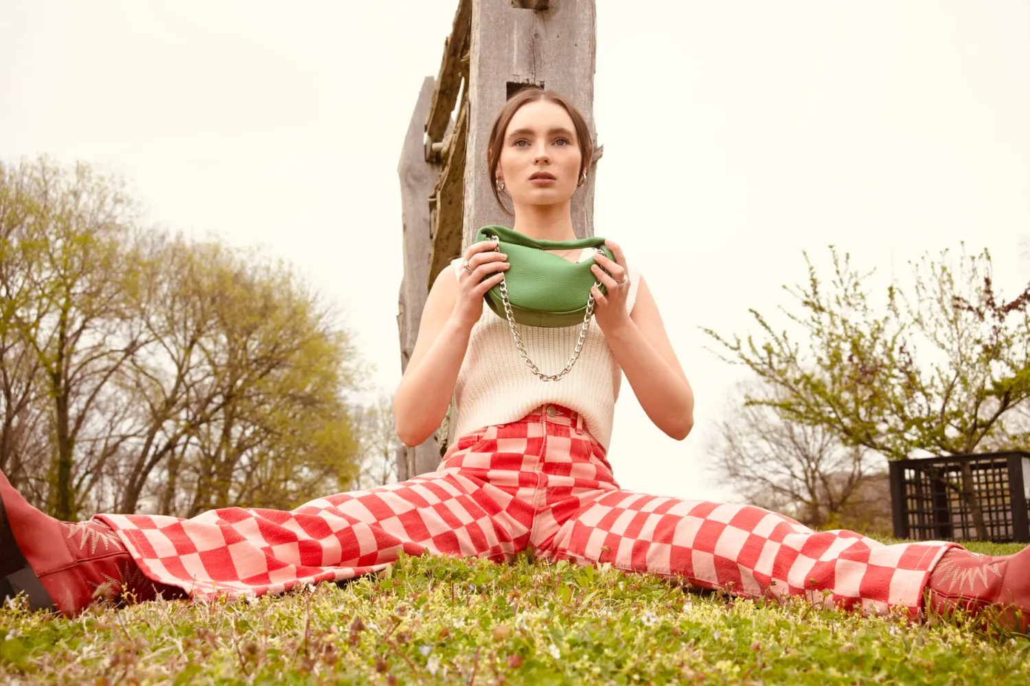 Person in red checkered outfit lounging on grass with various casual poses.