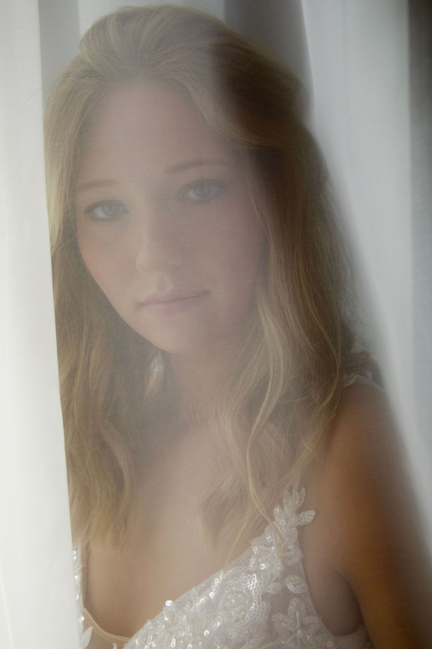 Dreamy portrait series of a woman in white lace dress with soft lighting and ethereal blurred edges.