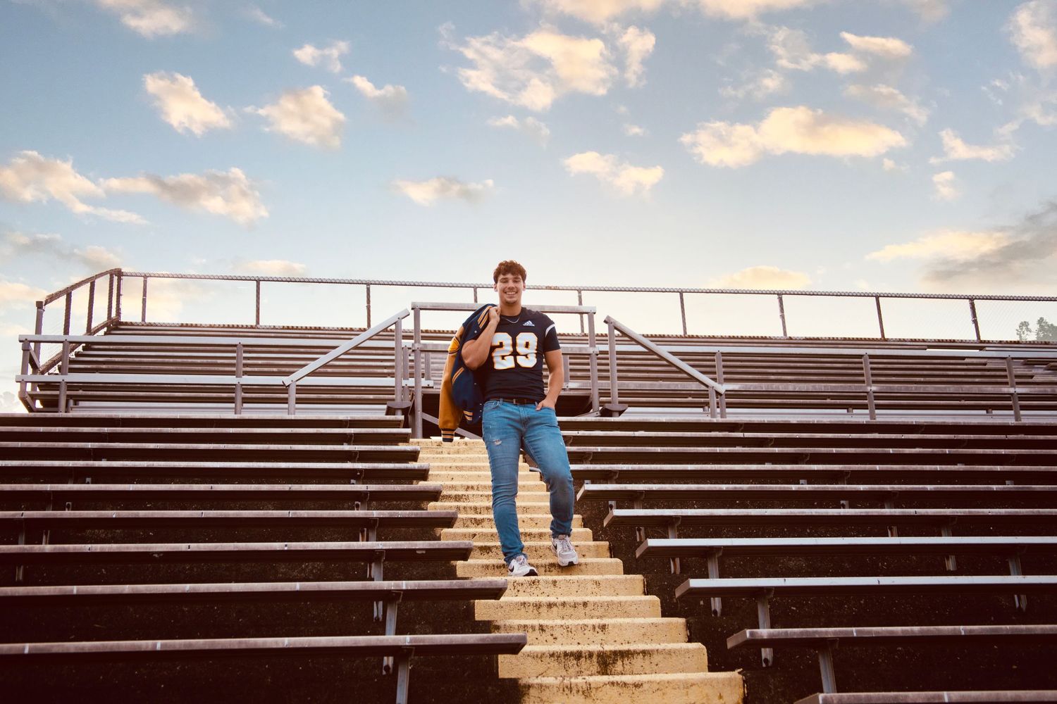A sequence of images showing someone walking up wooden bleachers against a sunset sky with puffy clouds.