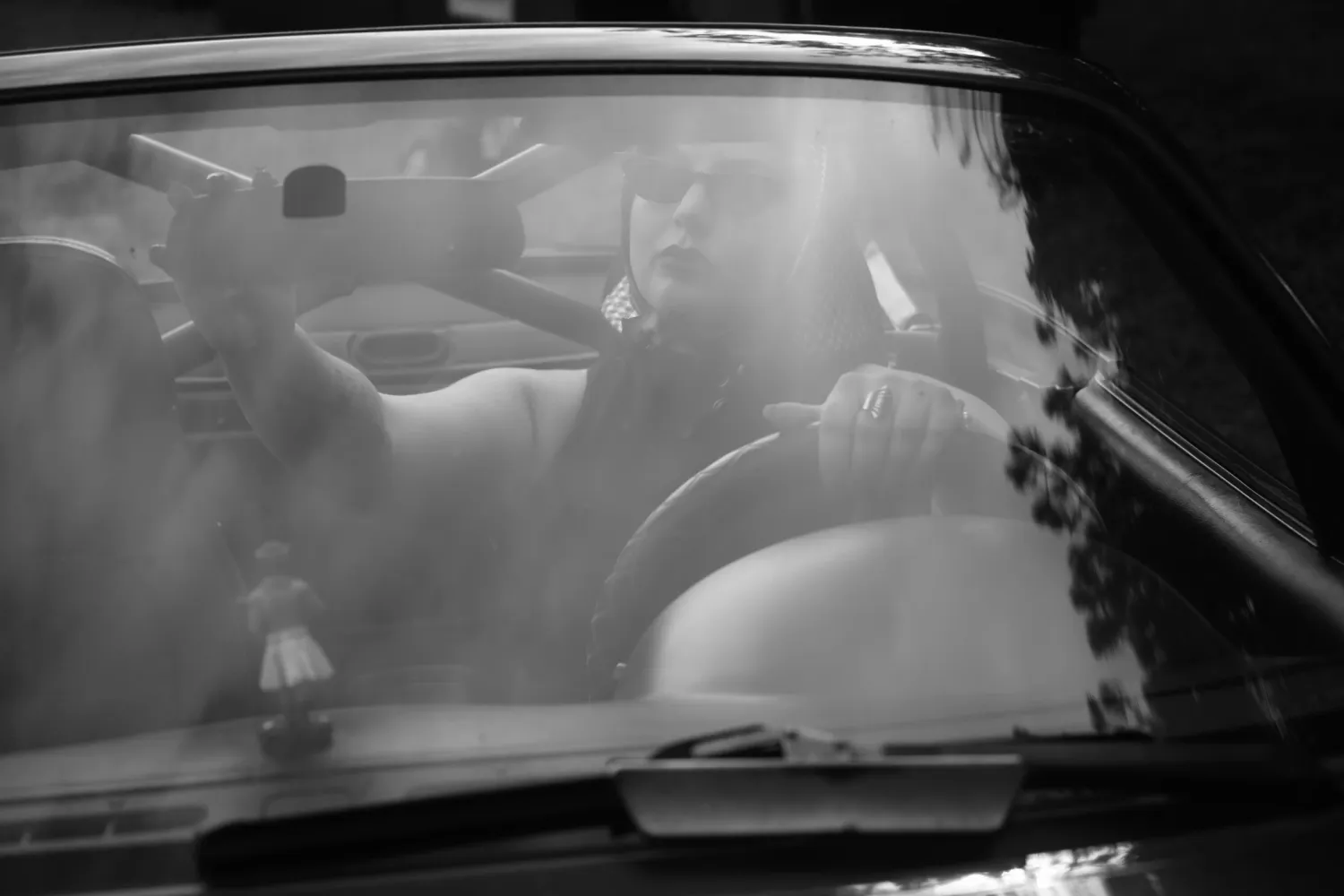 A series of black and white dashcam footage stills showing a nighttime traffic scene through a car windshield.