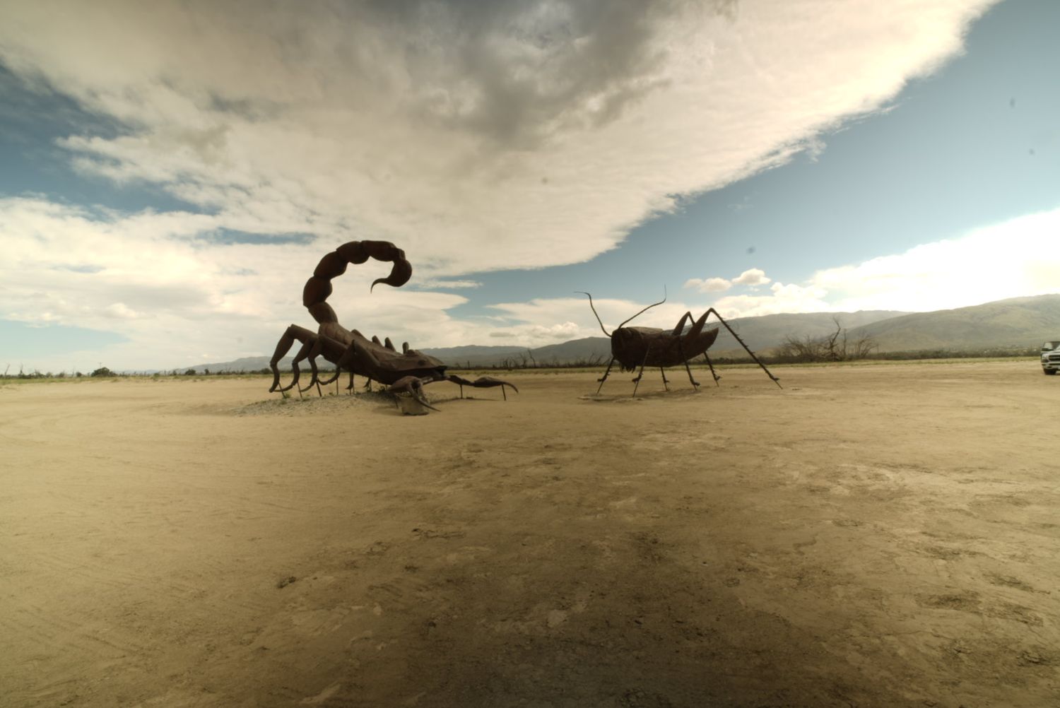 Digital artwork of giant scorpions facing off in a desert landscape.