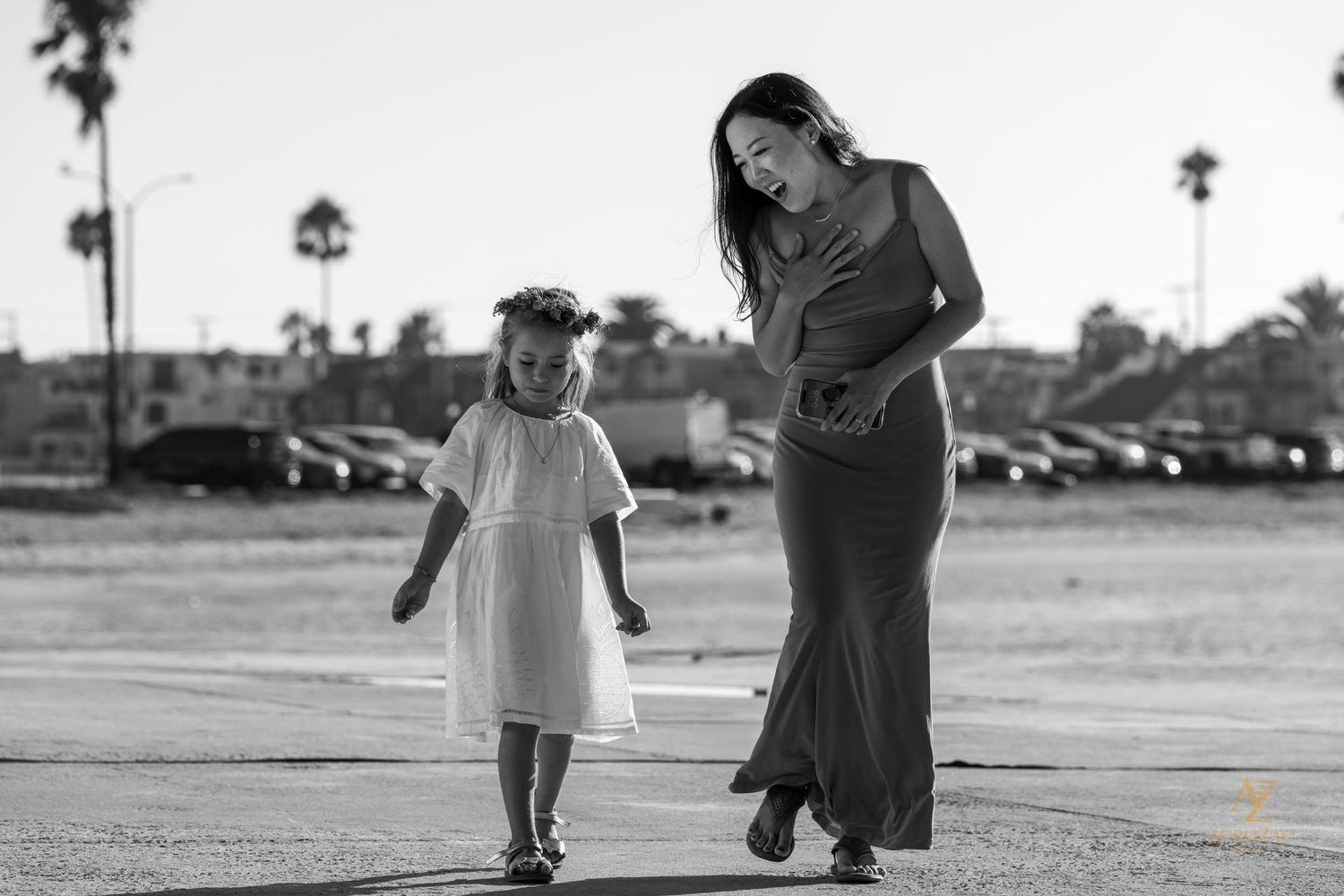 Black and white candid photo of wedding guests walking outdoors.