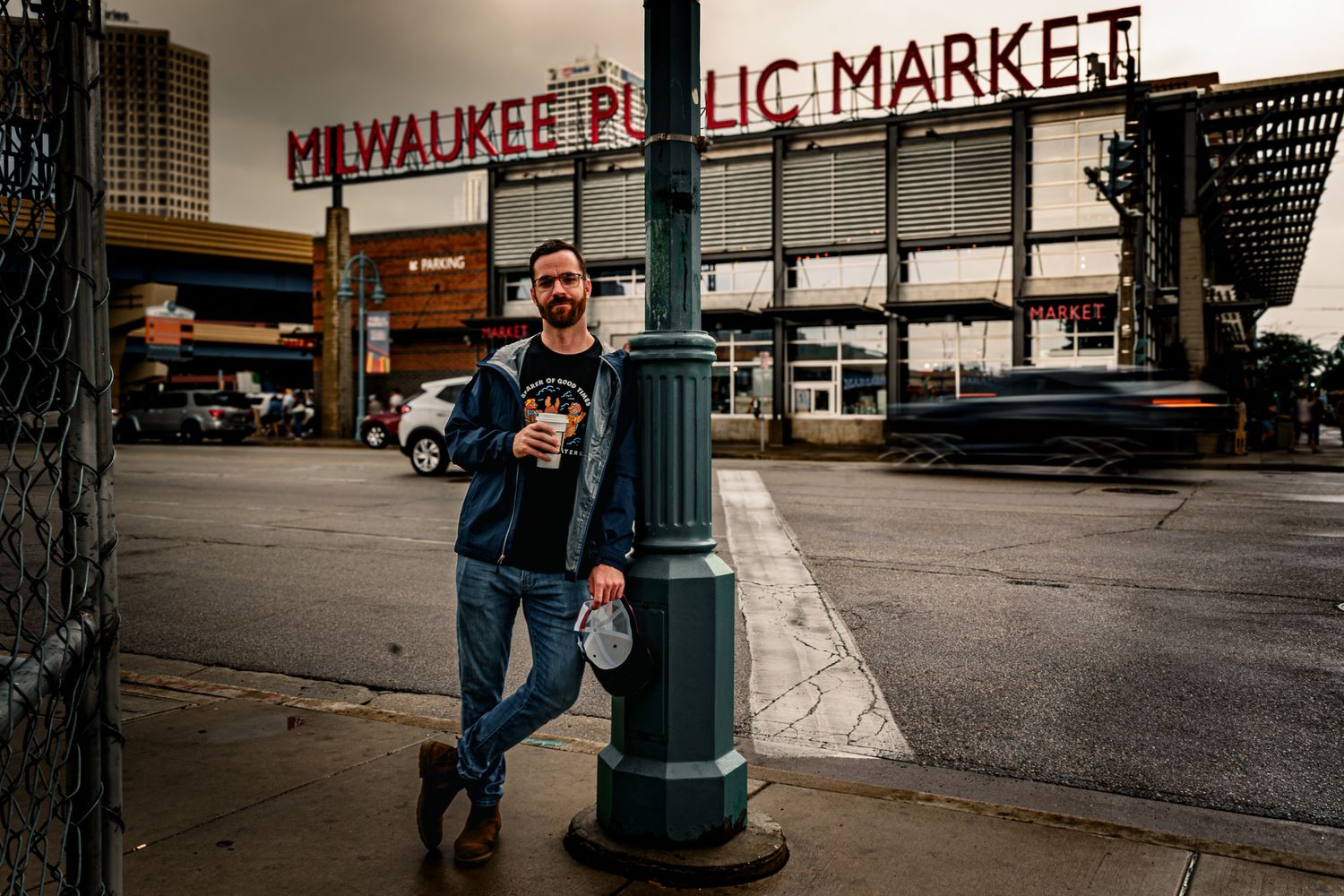Vintage signage of Milwaukee Public Market against an urban backdrop.