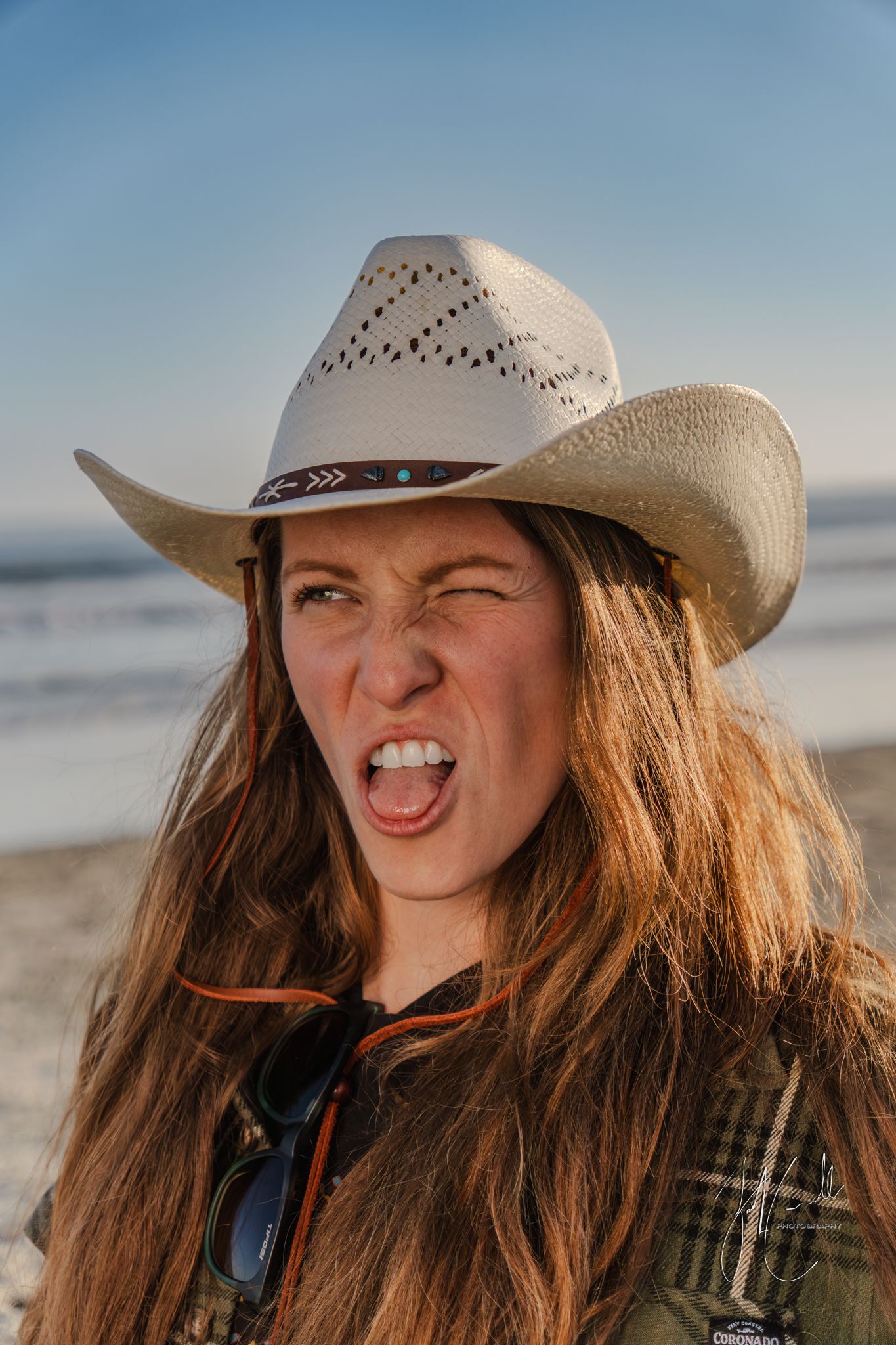 Sequence of expressions wearing a cowboy hat at the beach during sunset.
