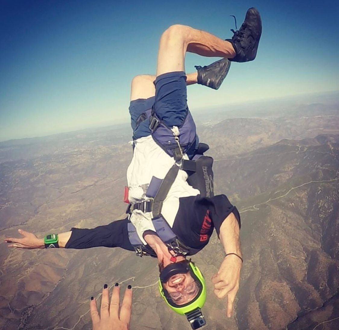 Sequence of skydiving maneuvers captured against a mountainous backdrop.