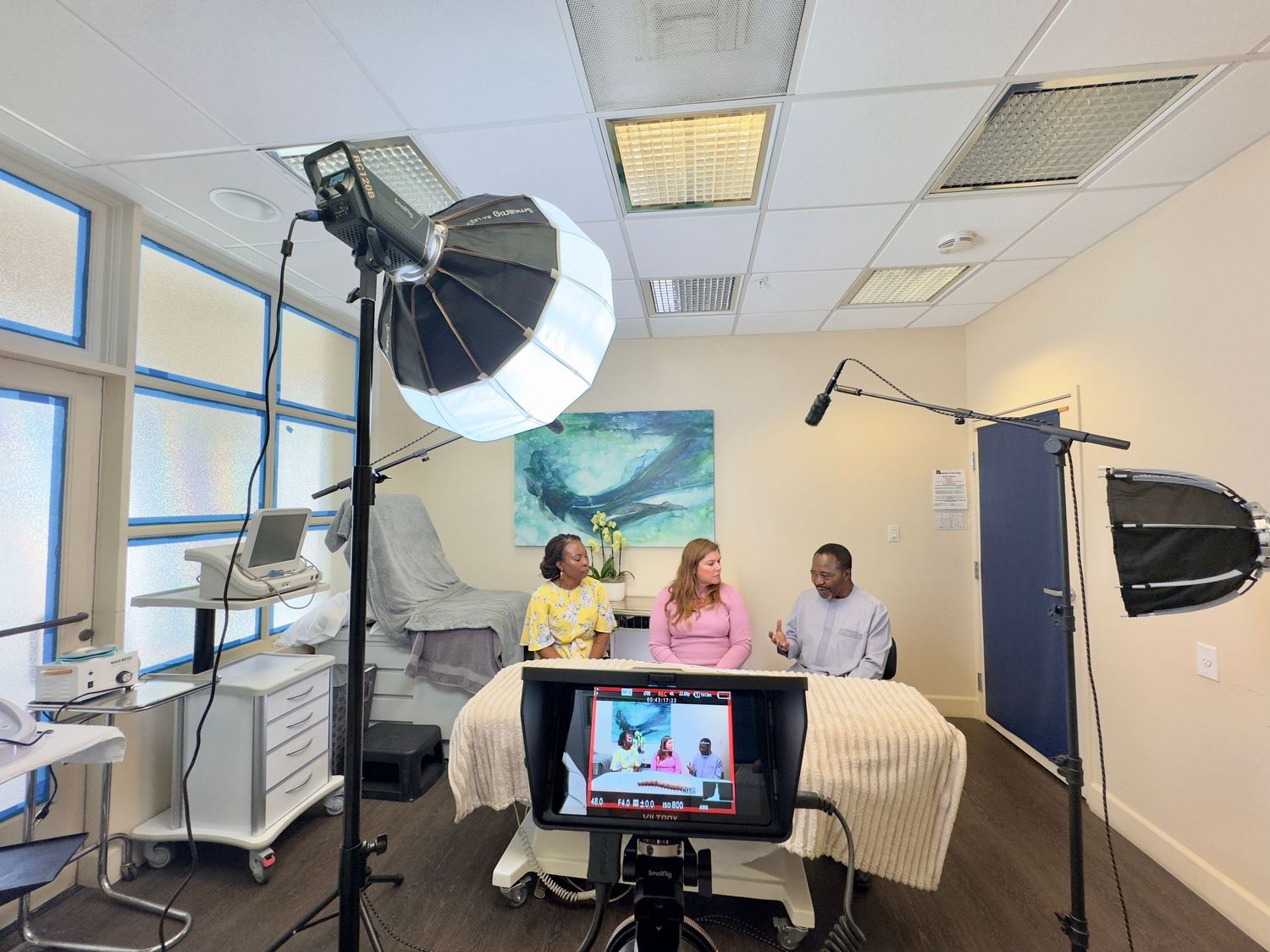 Medical examination room with lighting equipment and monitors set up for procedures.