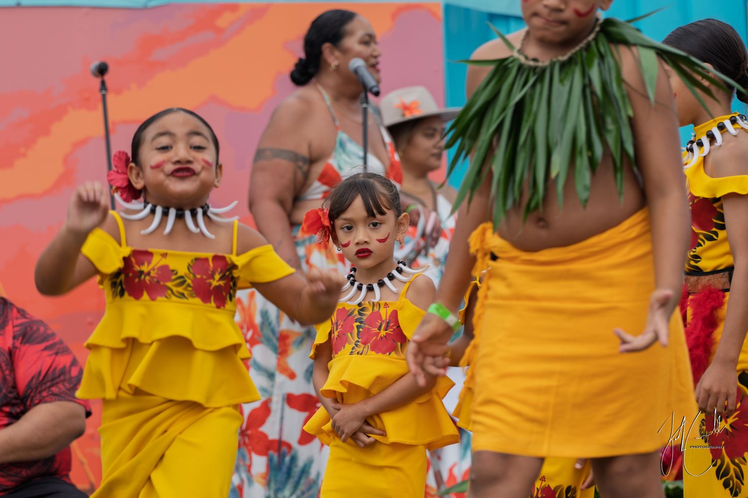 Colorful festival performance with dancers in bright yellow costumes.
