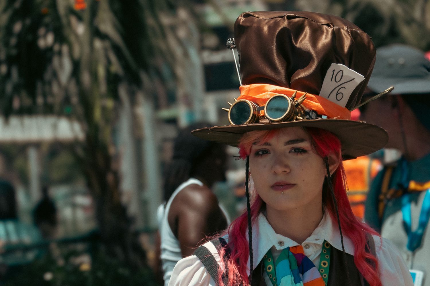 People wearing western-style hats and clothing at an outdoor event.