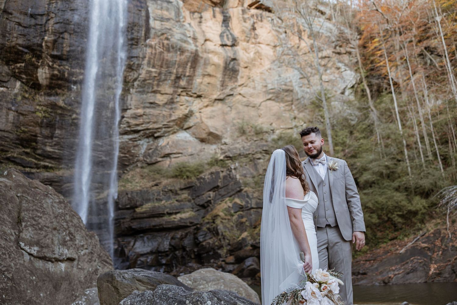Artistic Wedding Photography of couple in front of stunning waterfall, ideal for a North Georgia or Tennessee adventure elopement.