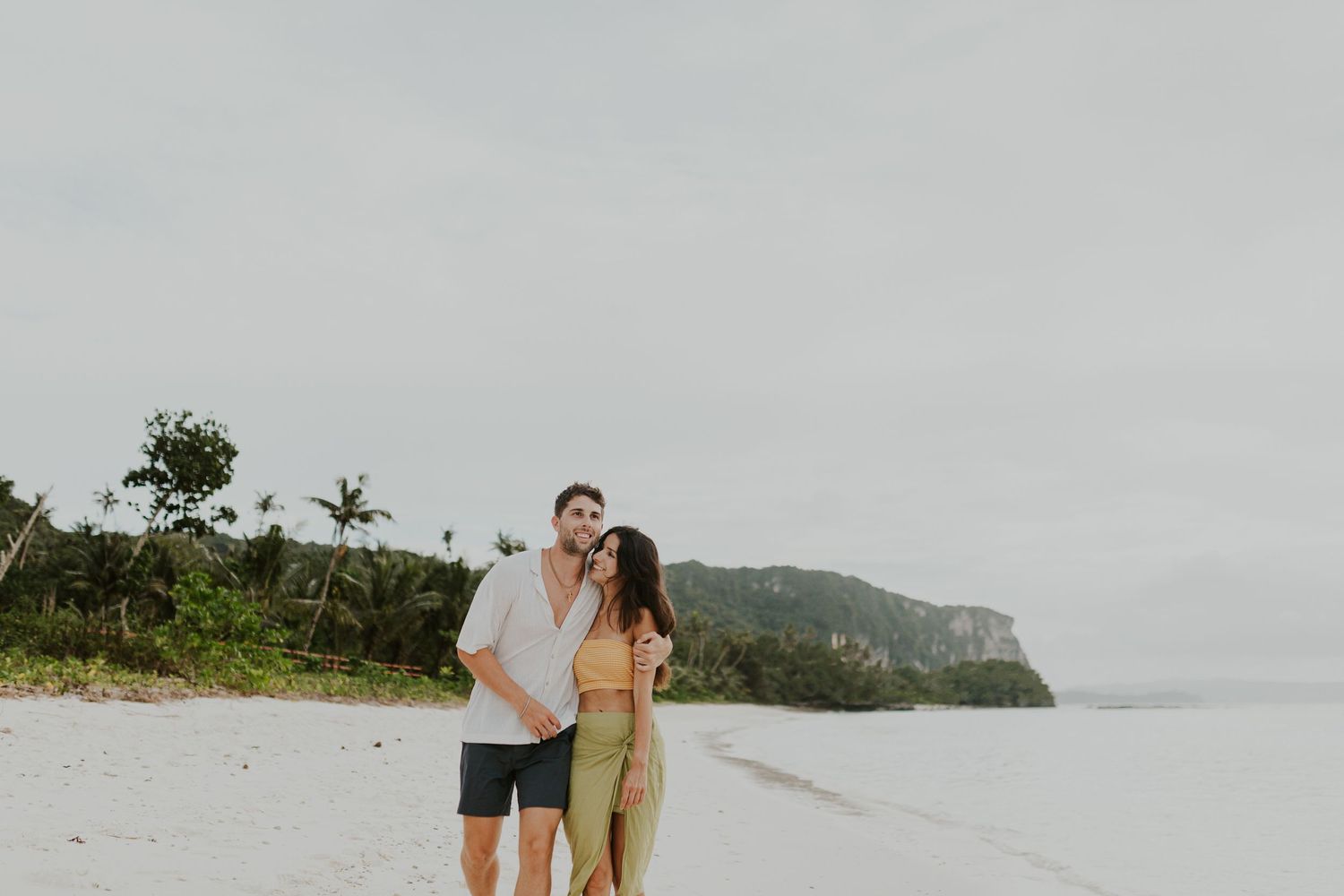 Luxury Destination Wedding Photography of an intimate couple portrait on a remote tropical white sand beach. High-end travel coverage.