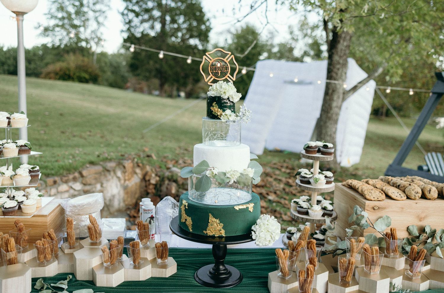 Luxury outdoor wedding reception details featuring a unique green cake, modern table settings, and high-end decor. Fine art wedding