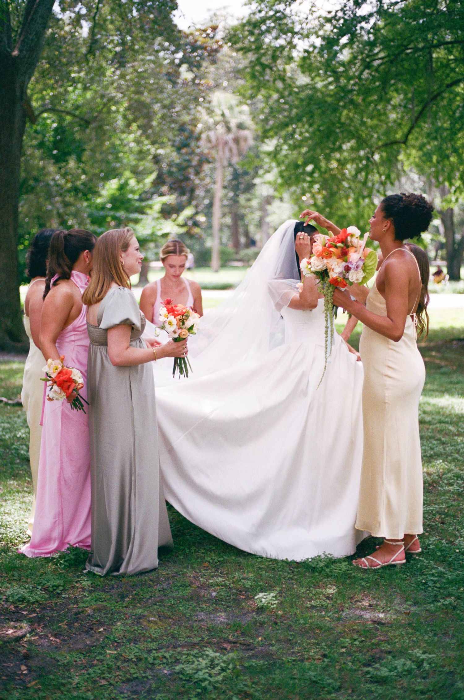 Wedding party photos showing bridesmaids in pastel dresses holding colorful bouquets outdoors.