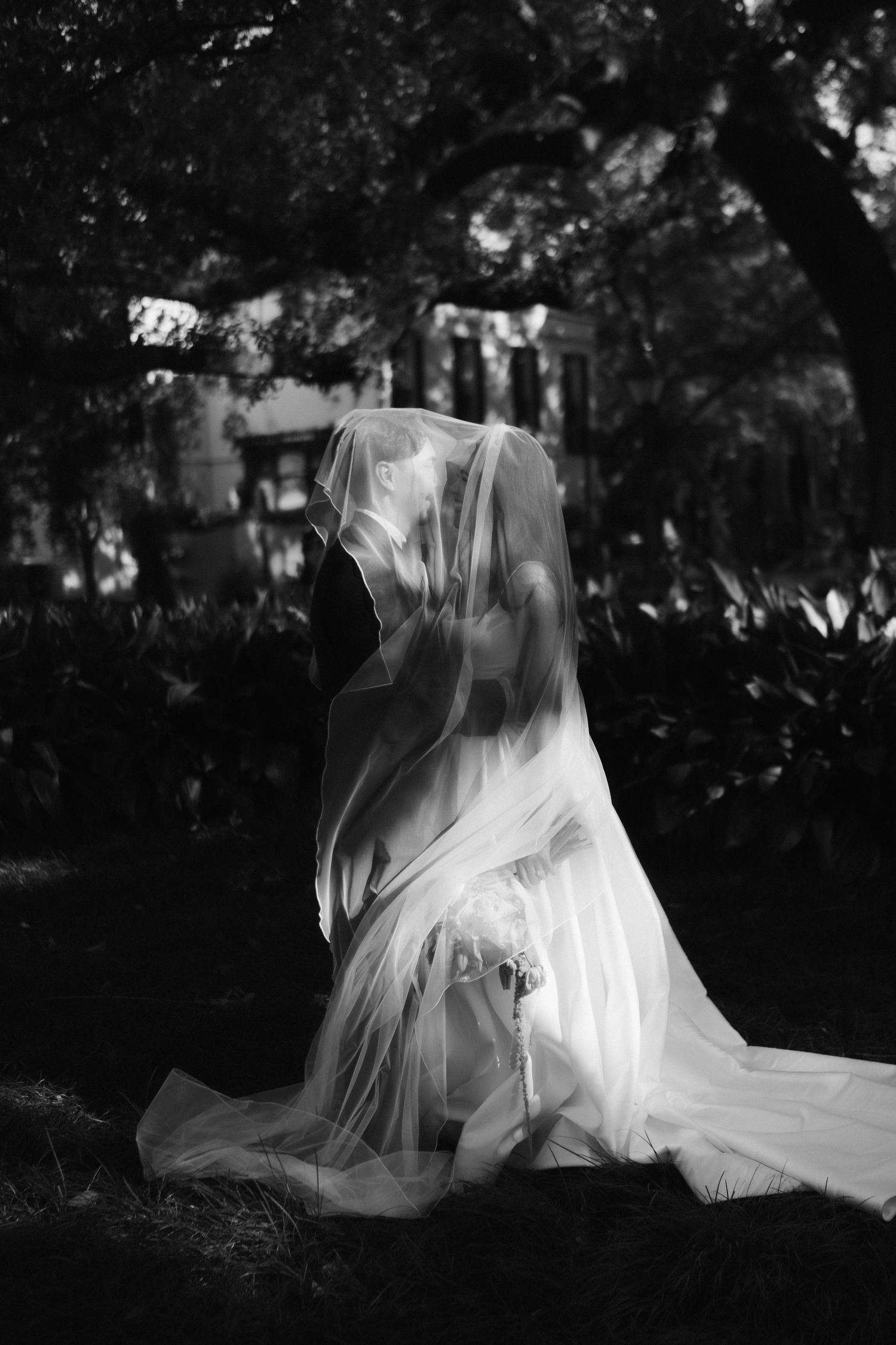 Artistic black and white sequence showing flowing white fabric in a garden setting.