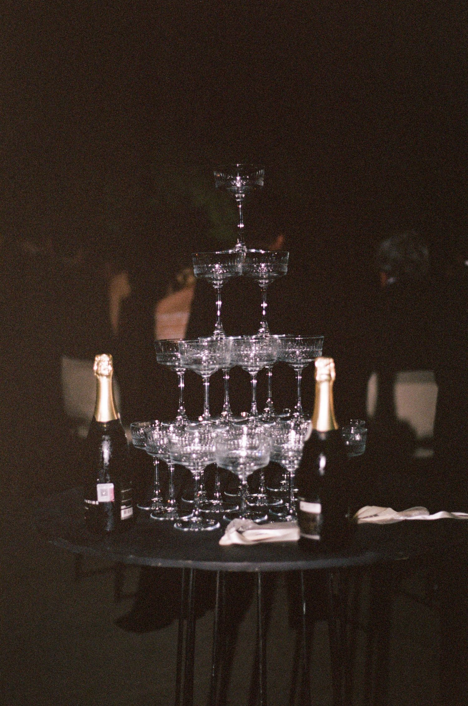 An elegant champagne tower display with crystal glasses arranged in tiers.