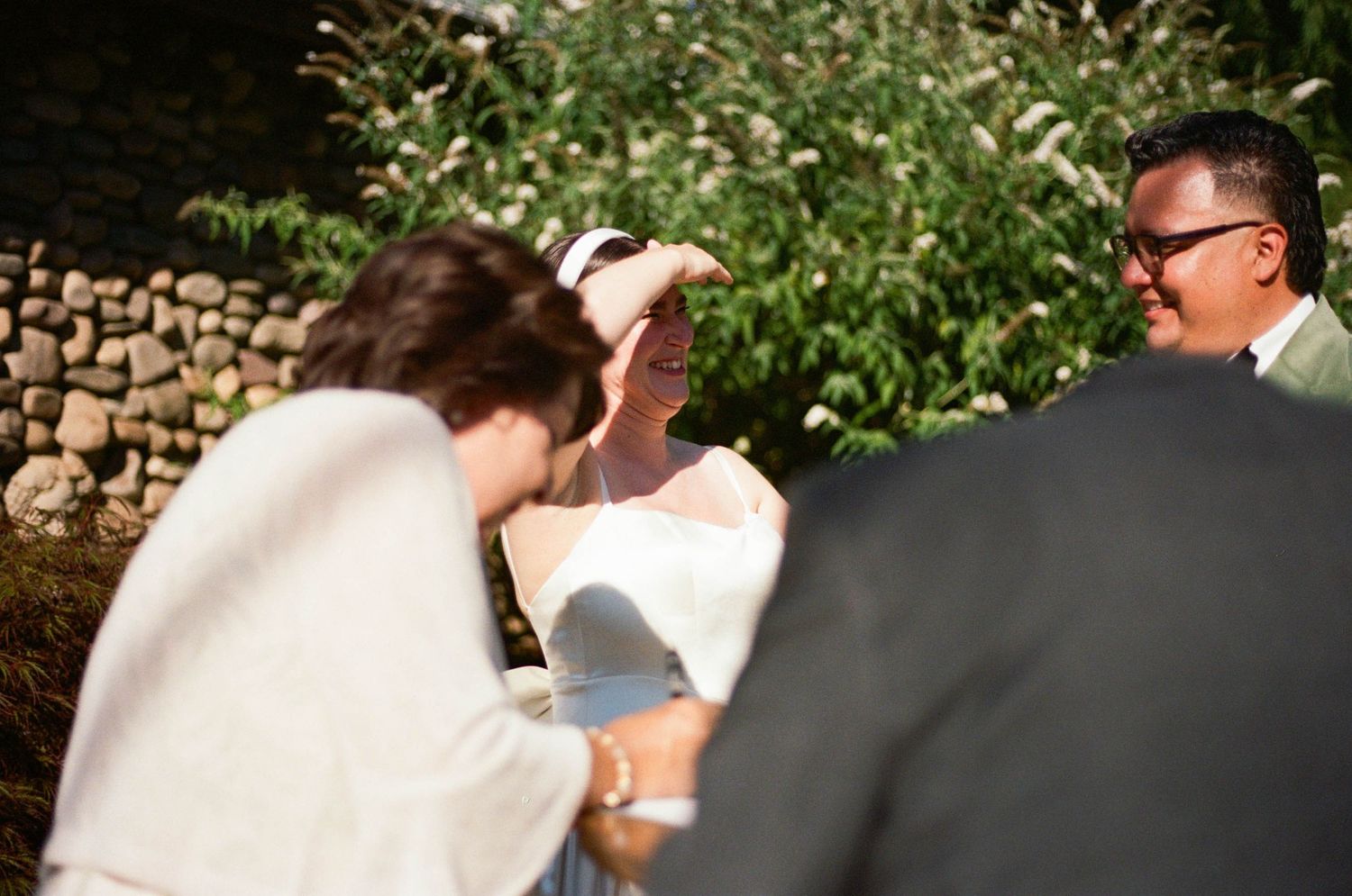 A candid moment captured during an outdoor wedding celebration.