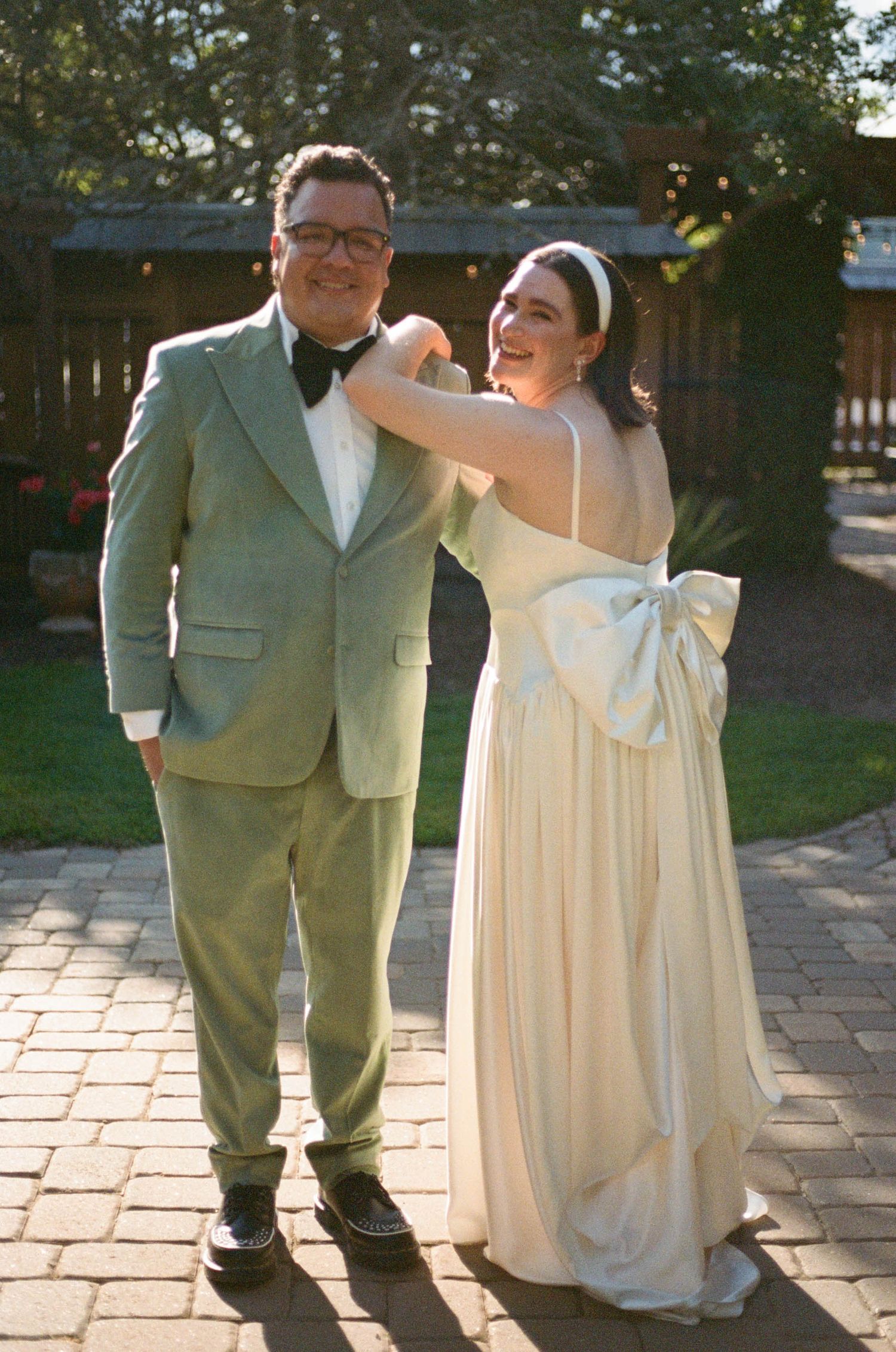 A joyful moment captured during a wedding celebration on a brick patio.