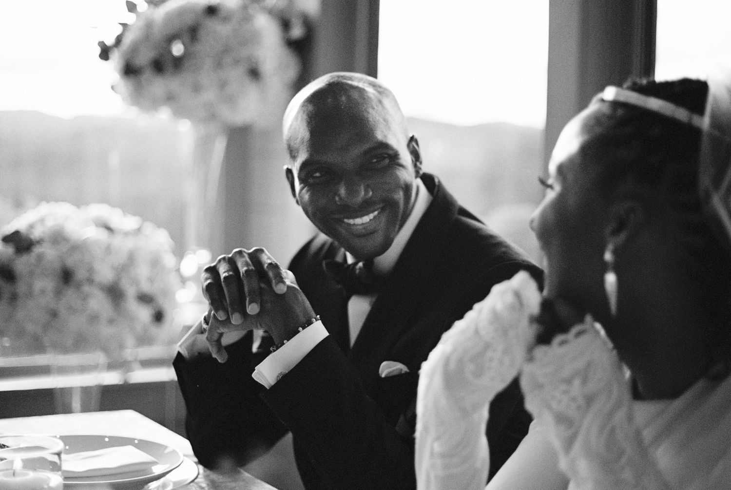 Candid black and white photos of wedding guests during emotional moments.