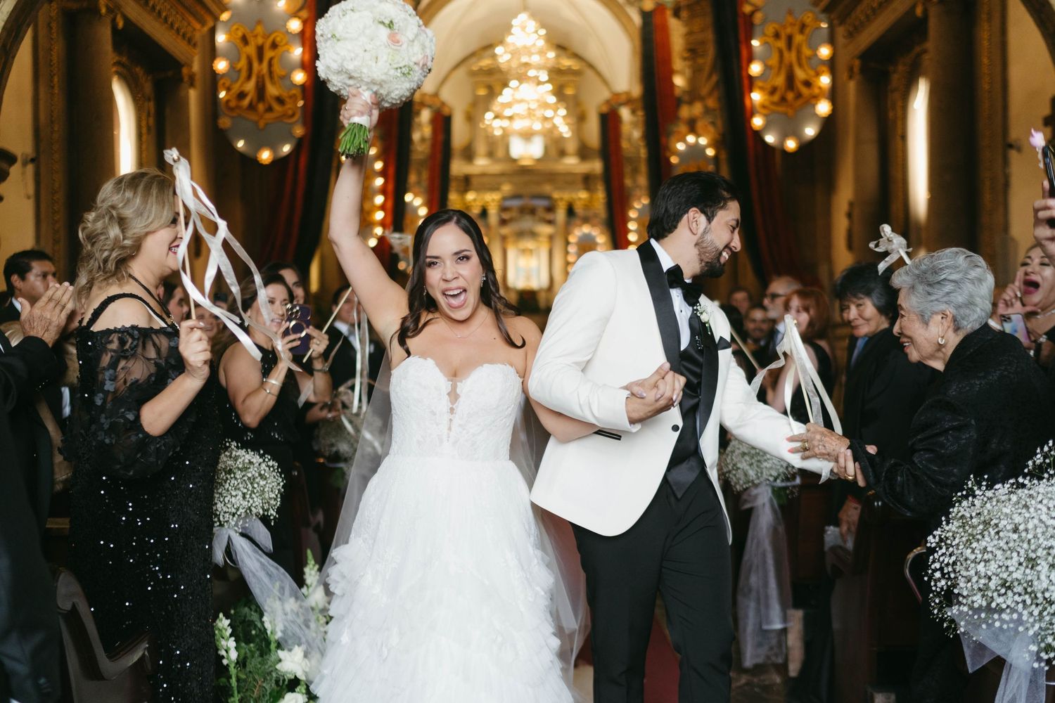 Wedding celebration in a beautifully lit historic church interior.