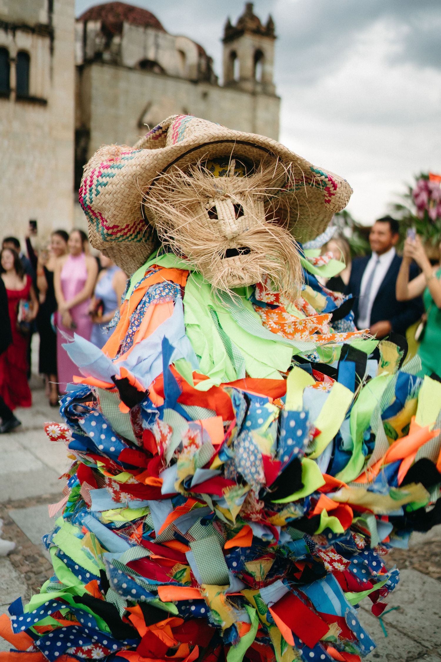 Colorful Mexican folk dancers in traditional costumes performing at an outdoor celebration.