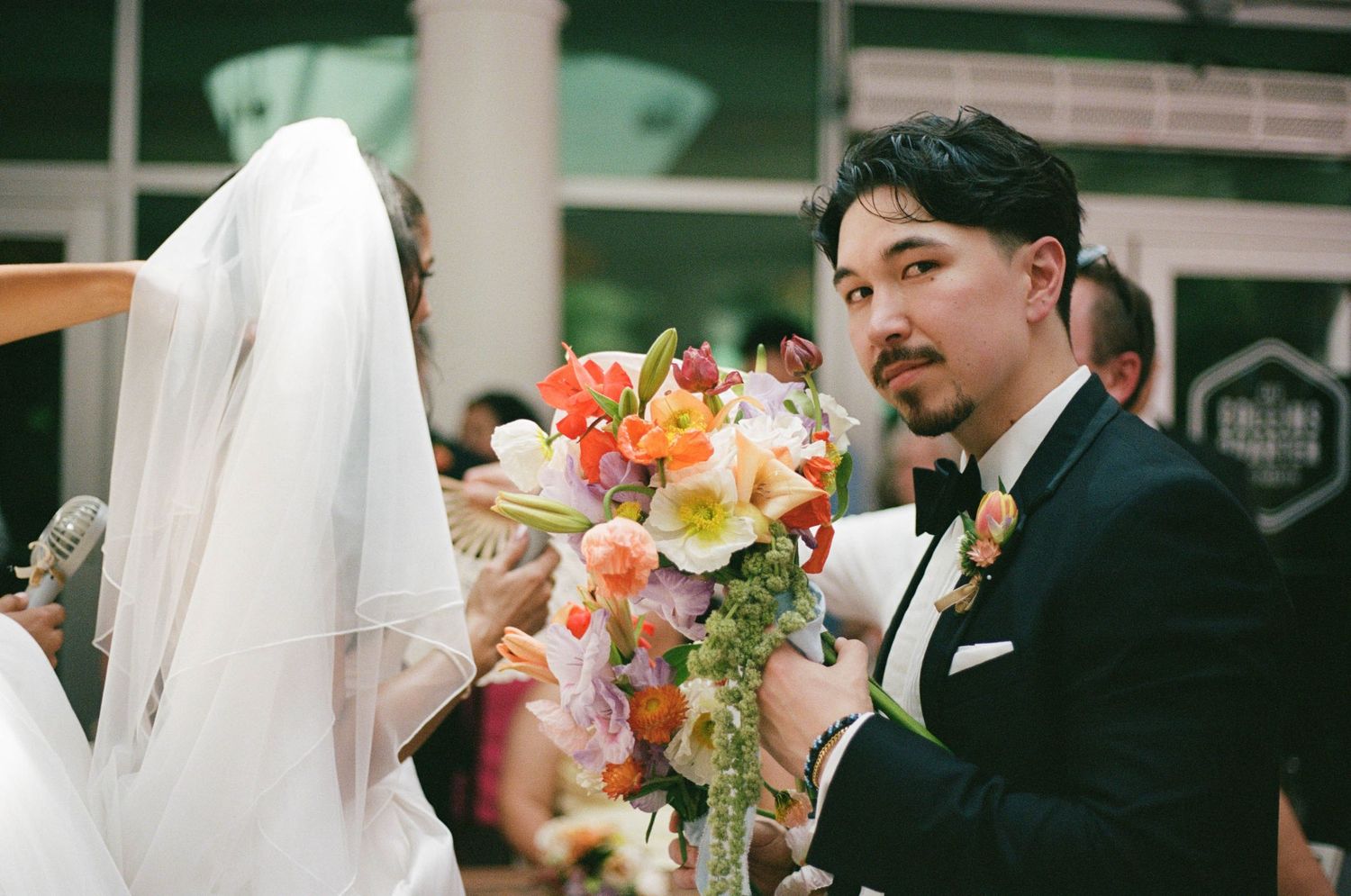 Close-up wedding photography sequence featuring floral arrangements and formal attire.