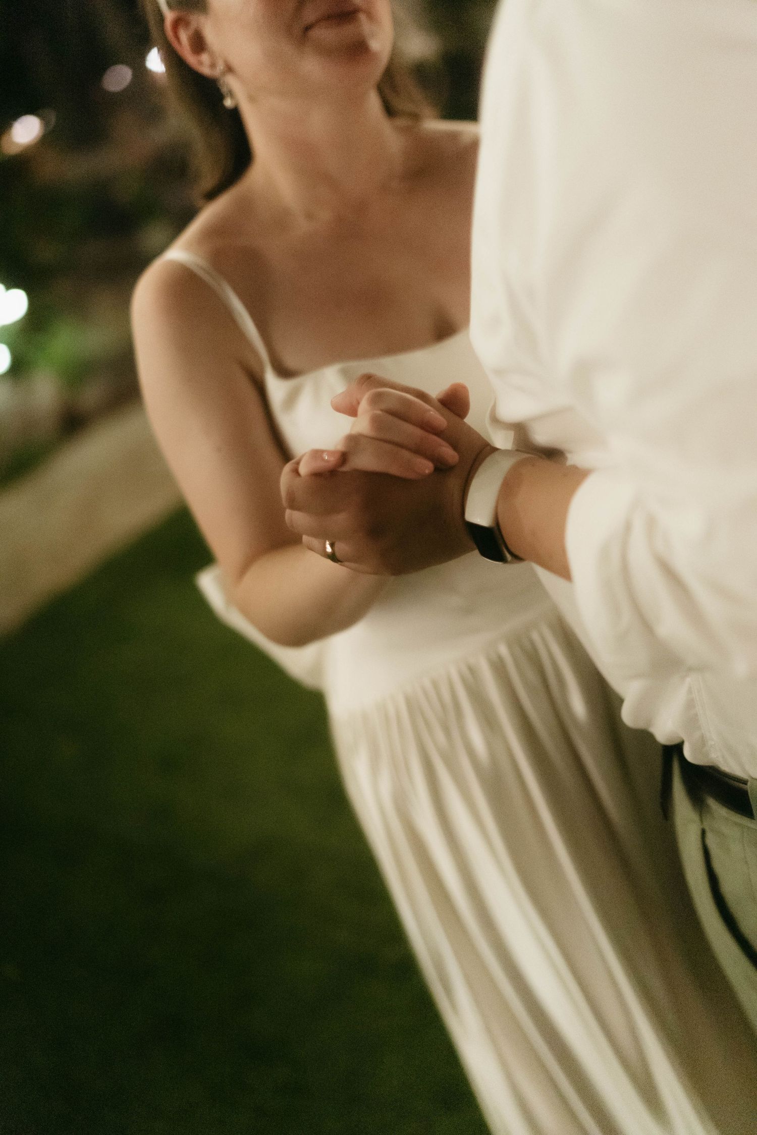 Close-up shot of a couple's intimate dance embrace in formal wedding attire.