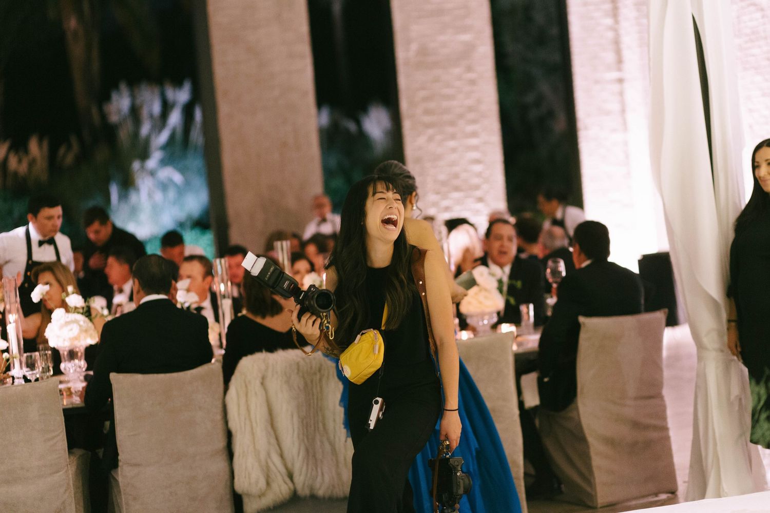 A lively indoor celebration scene with guests mingling at an elegant event venue.