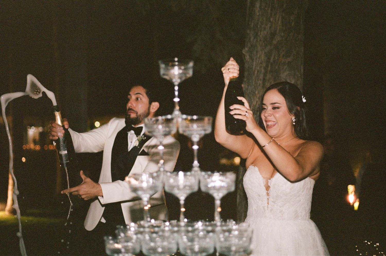 A celebratory moment at a wedding reception with a champagne tower display.