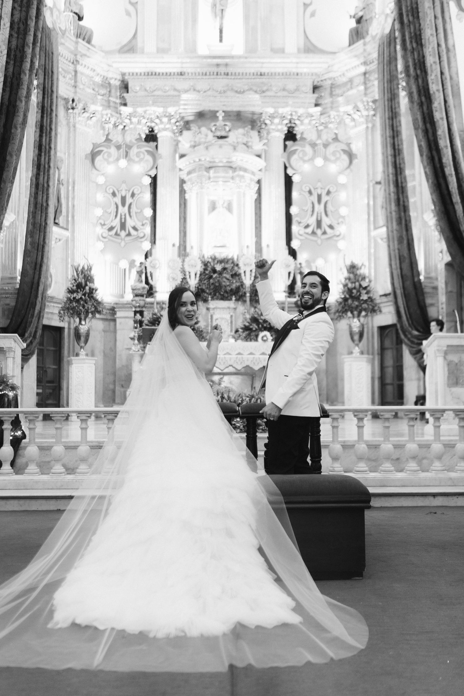 Black and white photo of a wedding dress silhouette in an ornate church interior.