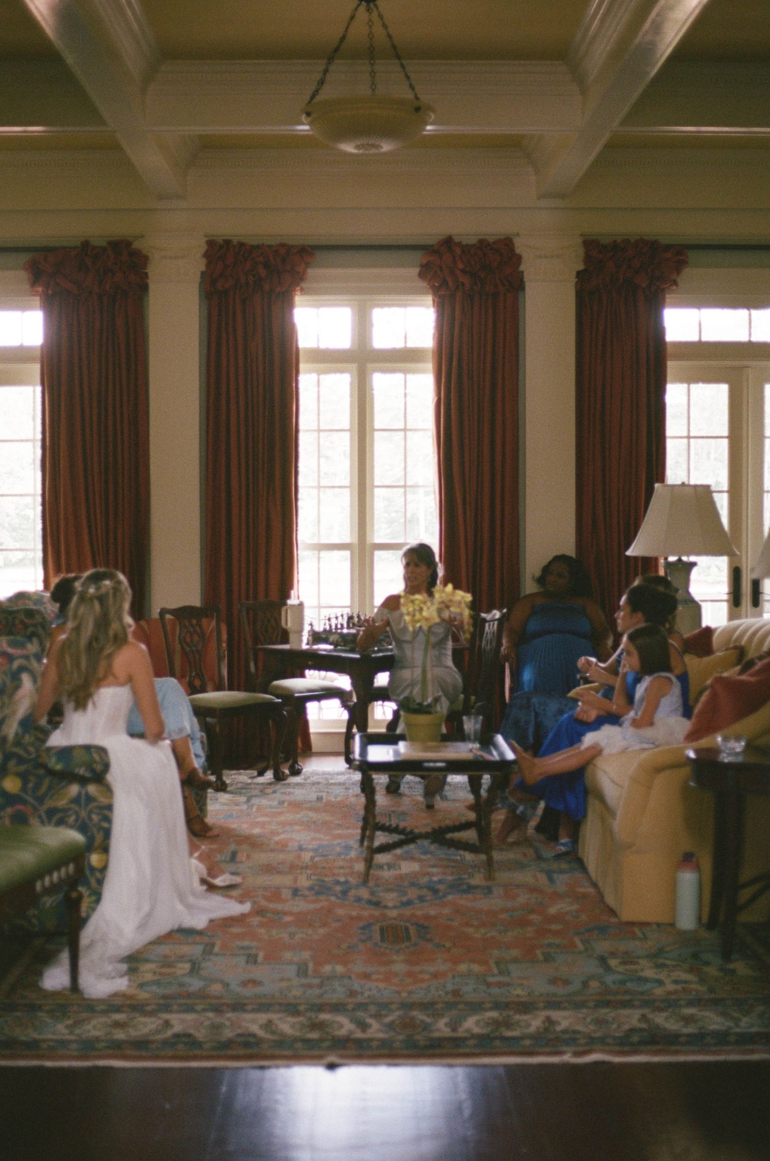 Bride and wedding party gathering in an elegant room before the ceremony.