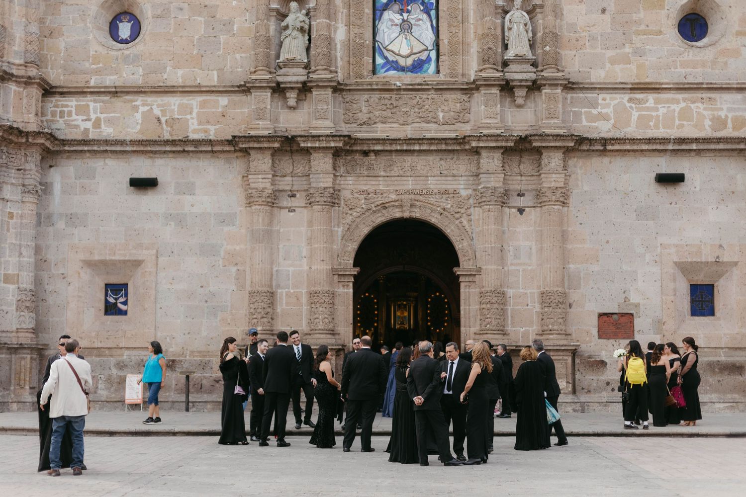 Stone facade of a historic church or cathedral with architectural details and arched entrances.