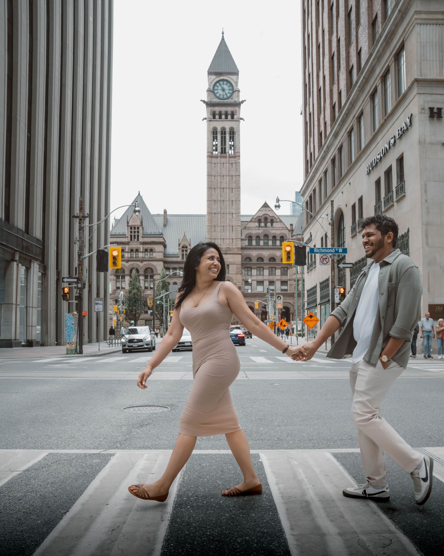 Couple holding hands during outdoor engagement session in Toronto