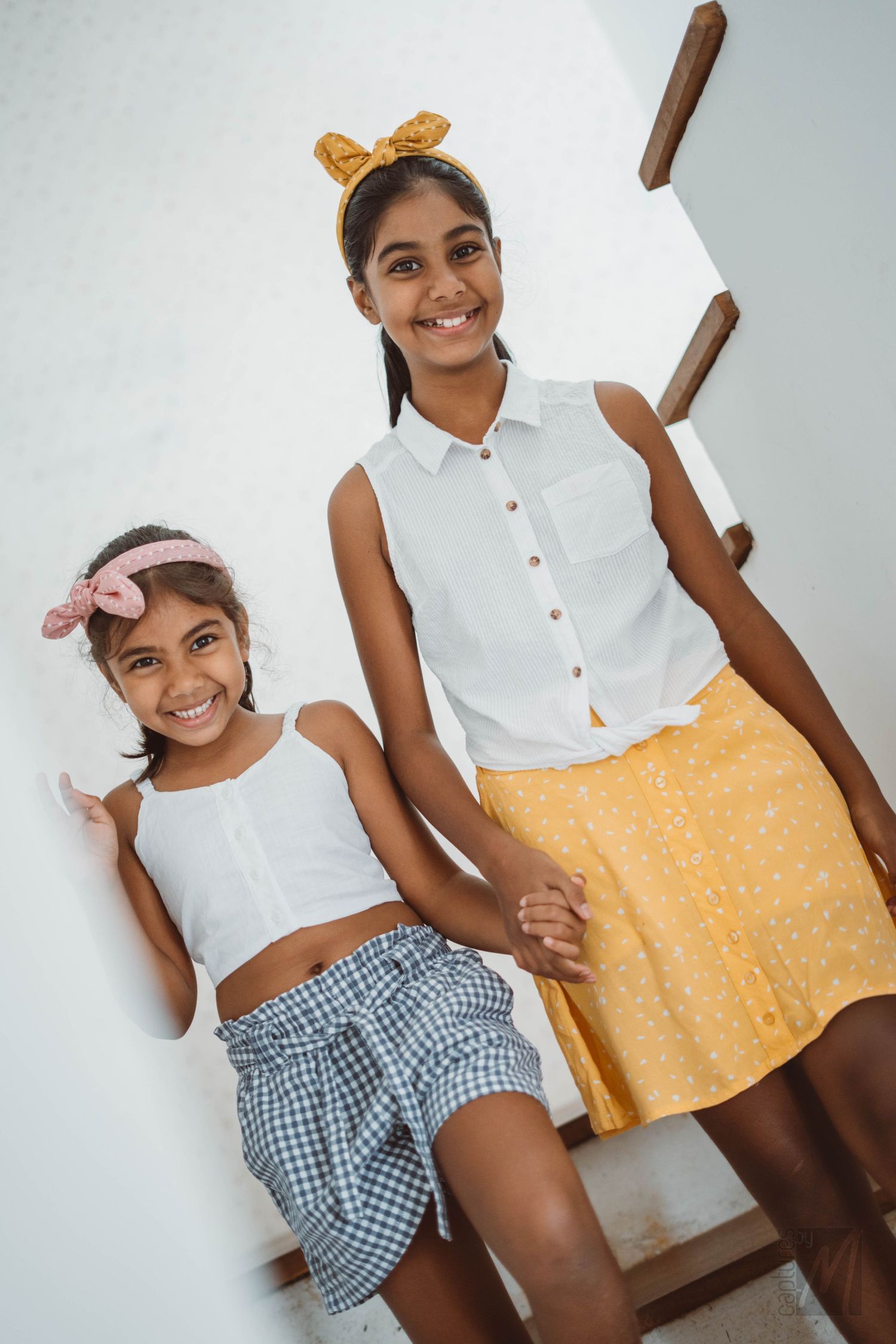 Portrait of two sisters standing together outdoors