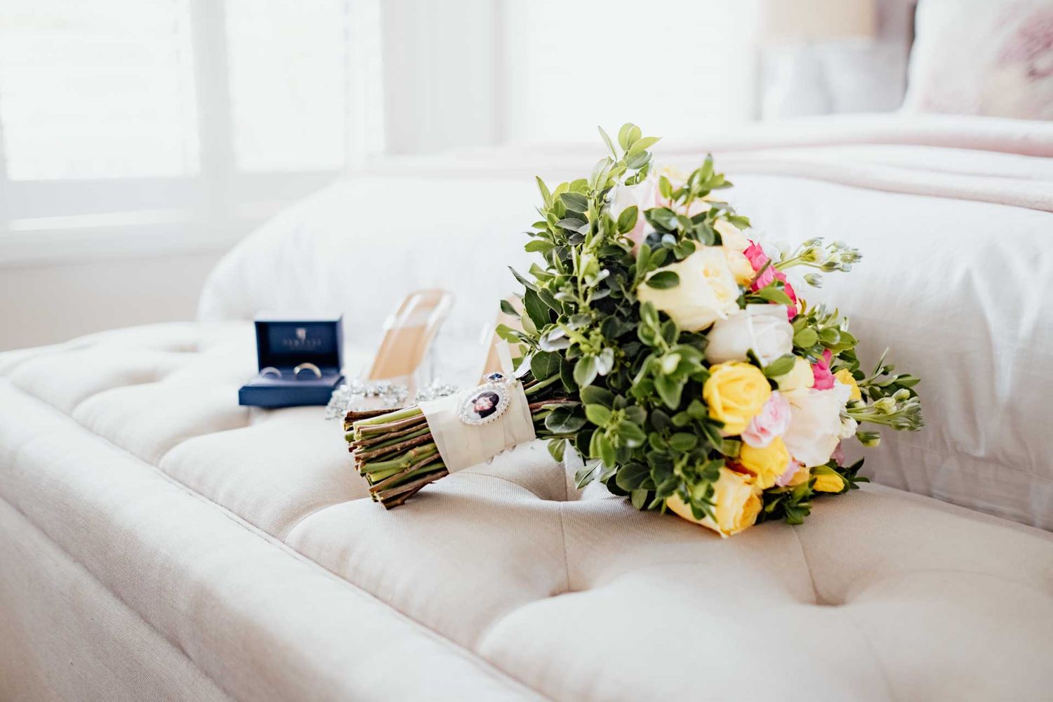 Brides bouquet, ring and shoes in a white room at a wedding in Tanunda, captured by Barossa Valley wedding photographer Matt Webster