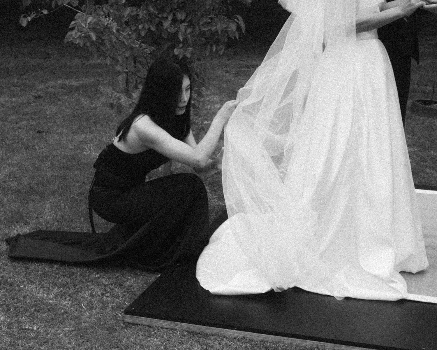 Bridesmaid fixes the brides wedding dress in Tanunda by Barossa Valley photographer Matt Webster