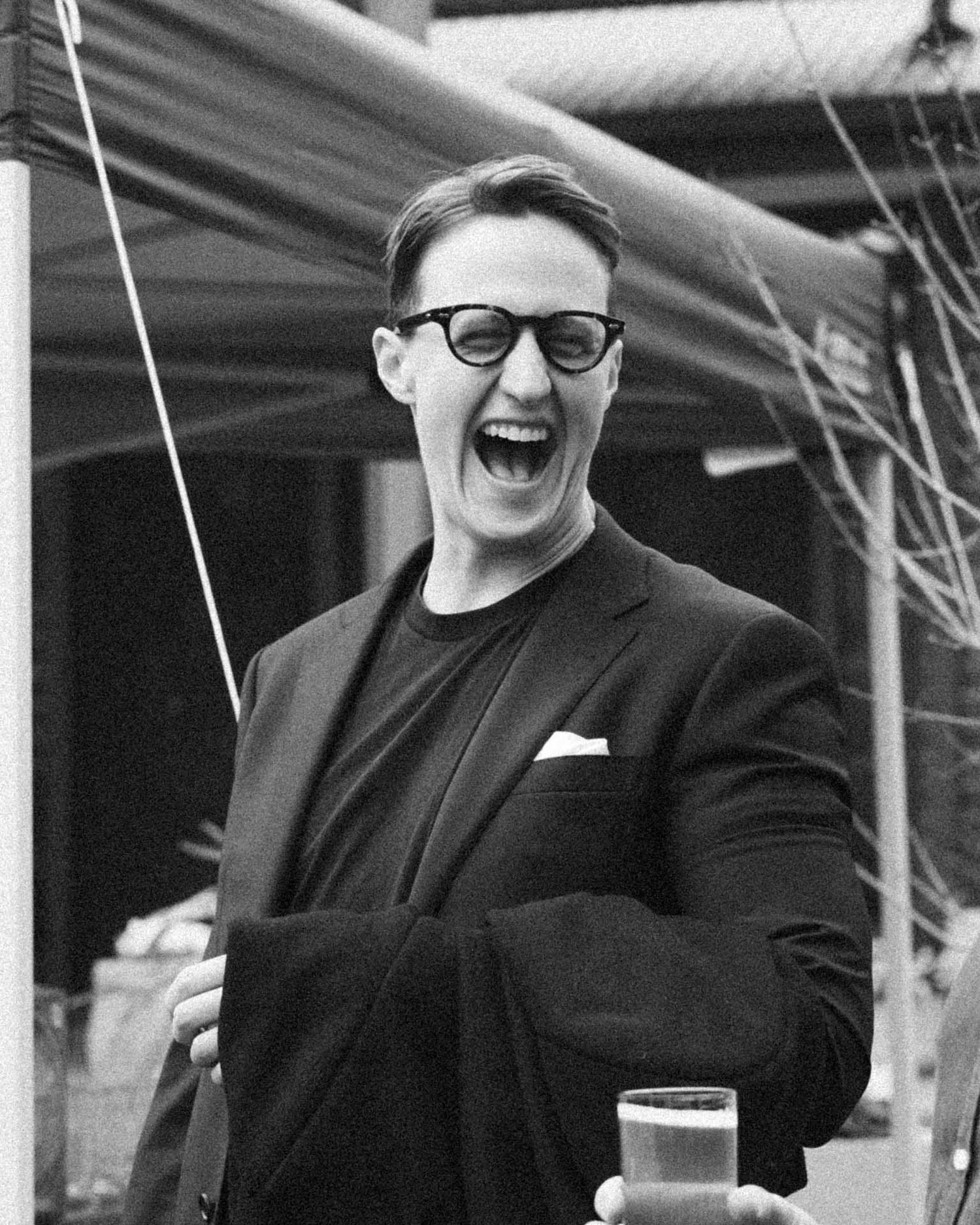 Candid moment of guests laughing during an outdoor wedding reception in Tanunda by Barossa Valley photographer Matt Webster