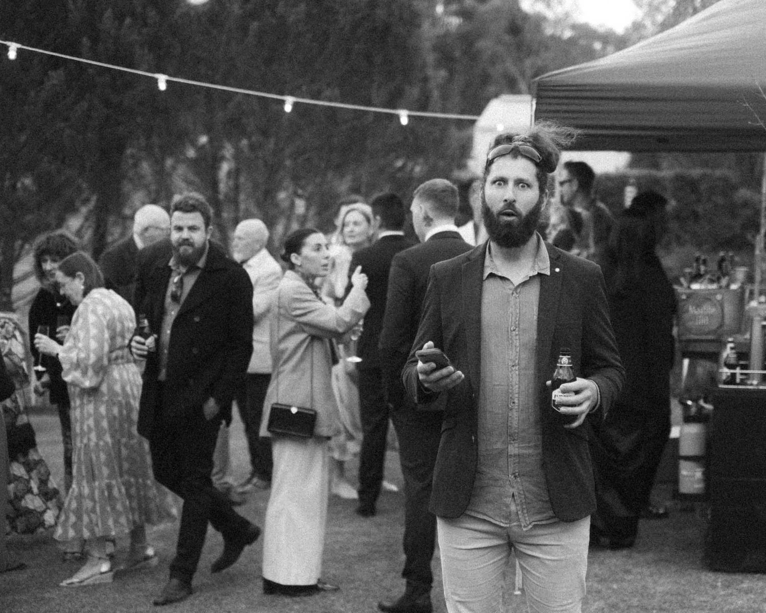 Candid moment in black and white of a guest during an outdoor wedding reception in Tanunda by Barossa Valley photographer Matt Webster
