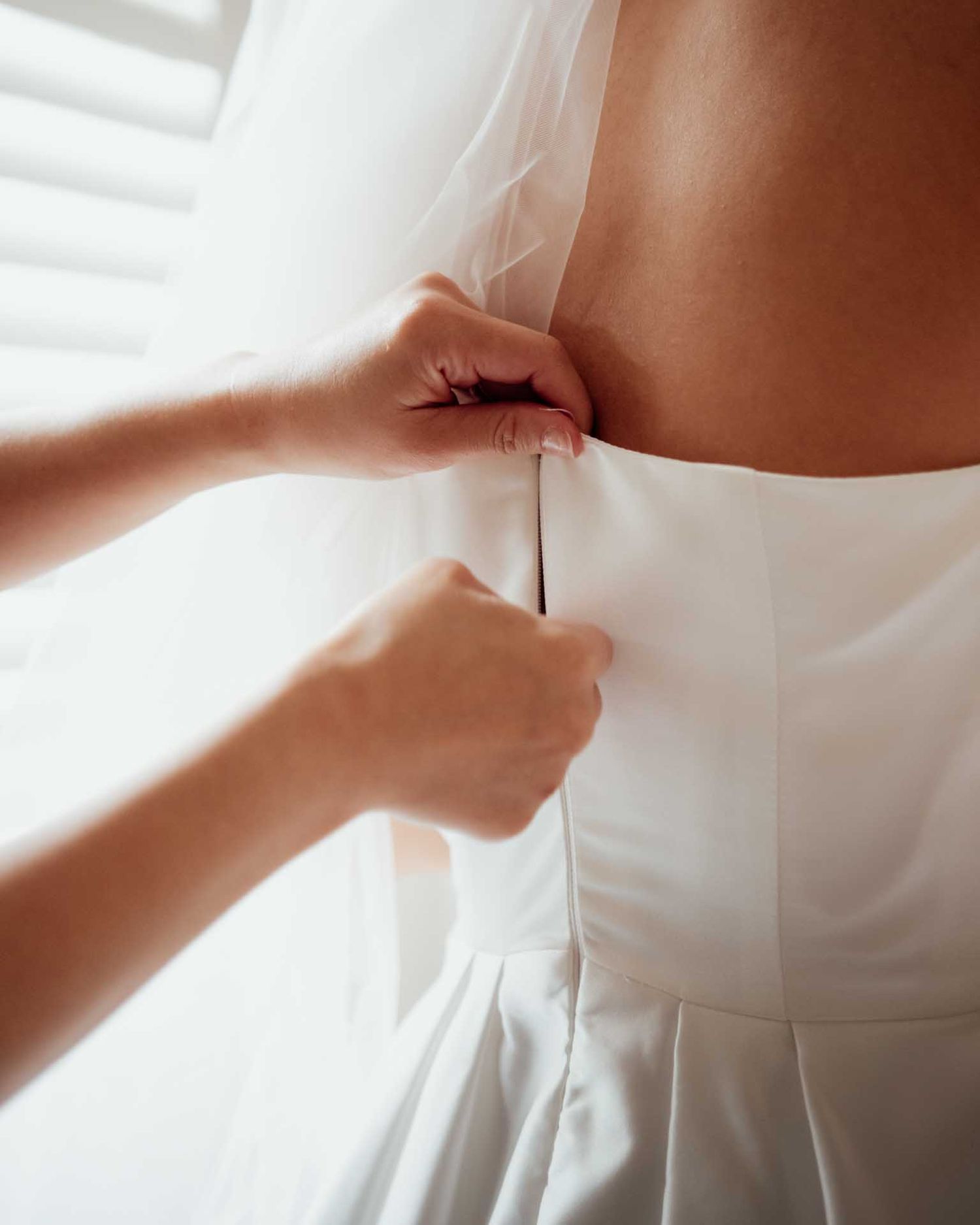 Brides wedding dress being zipped up before her wedding in Tanunda, captured by Barossa Valley wedding photographer Matt Webster