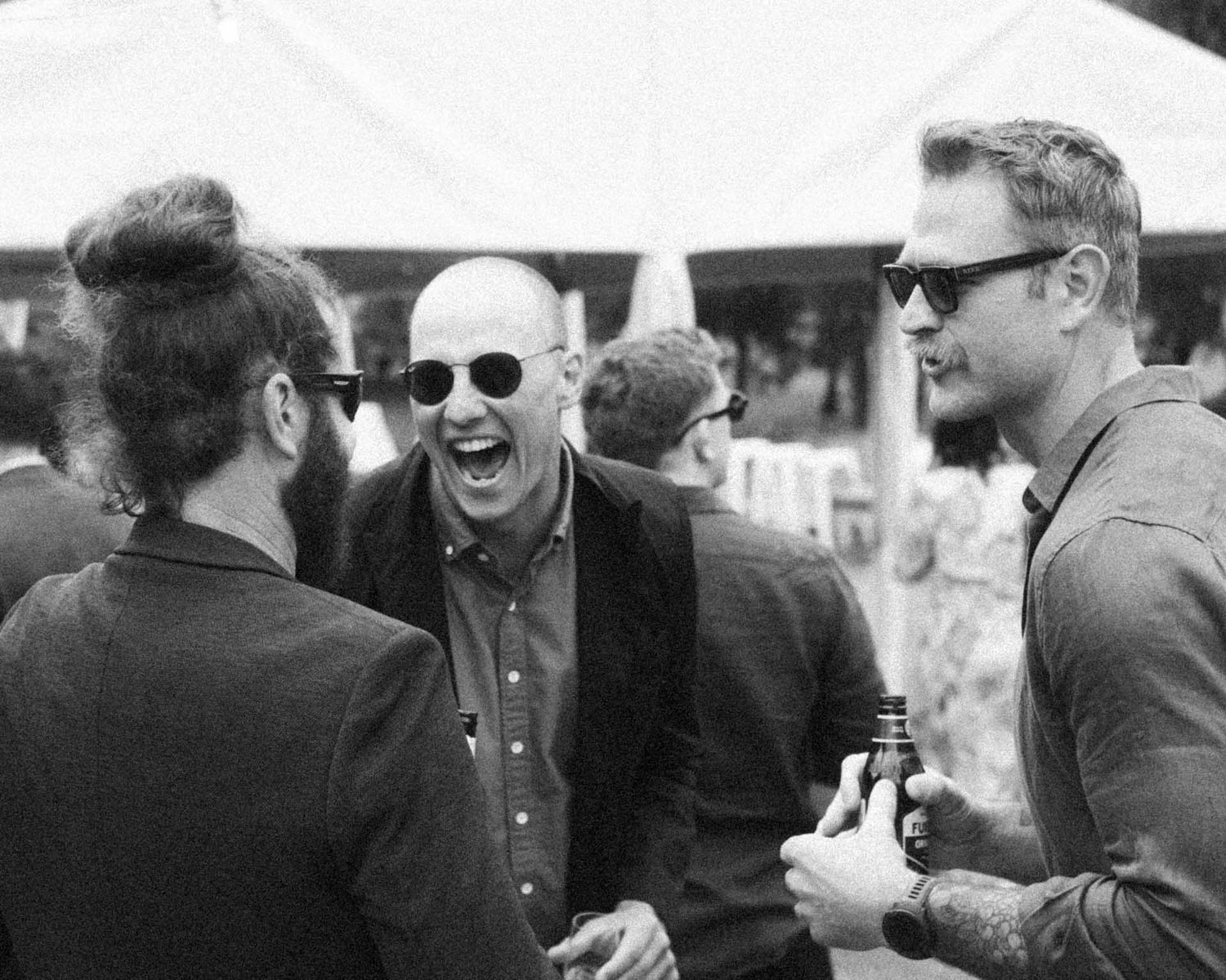 Candid moment of guests laughing during an outdoor wedding reception in Tanunda by Barossa Valley photographer Matt Webster