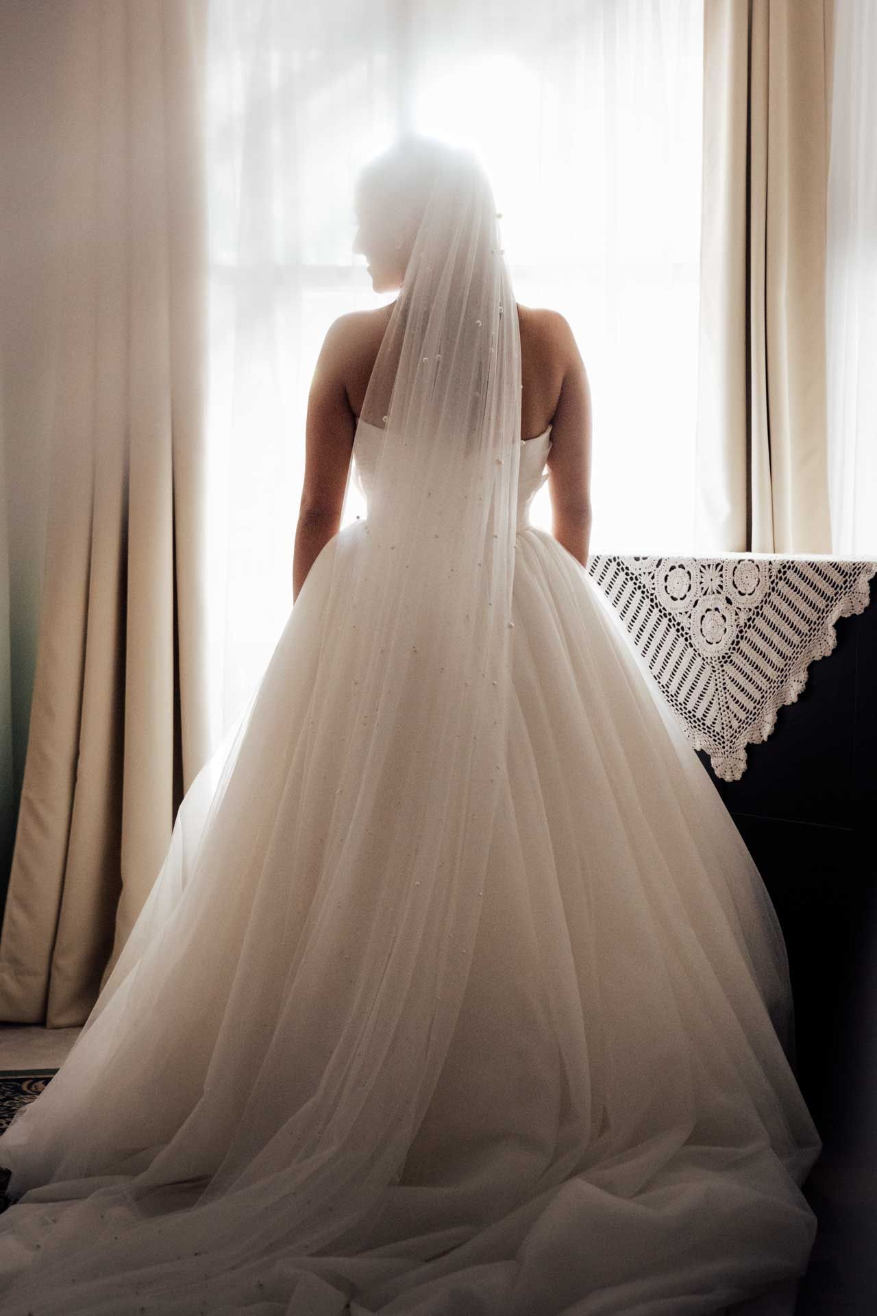 Ethereal portrait of bride in her wedding gown surrounded by soft sunlight, photographed by Barossa Valley photographer Matt Webster.
