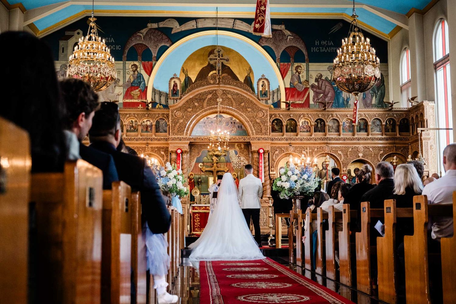 Bride and groom standing at the altar of St George Orthodox Church, Thebarton, captured by Matt Webster.