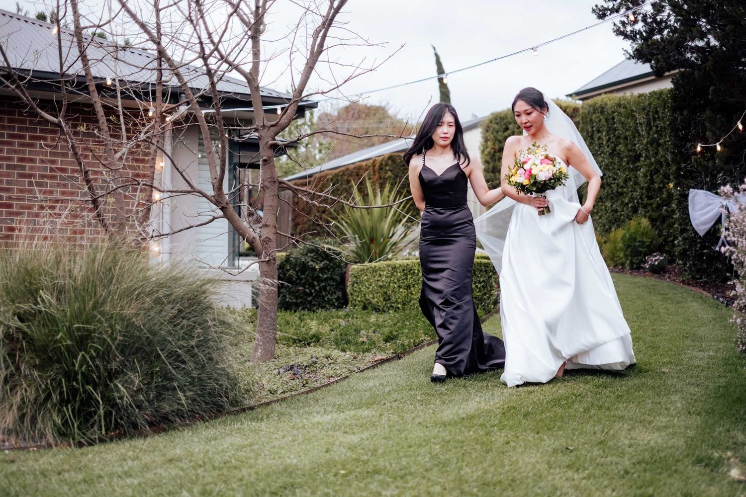 Bride walking down the isle with her sister for her wedding in Tanunda by Barossa Valley photographer Matt Webster