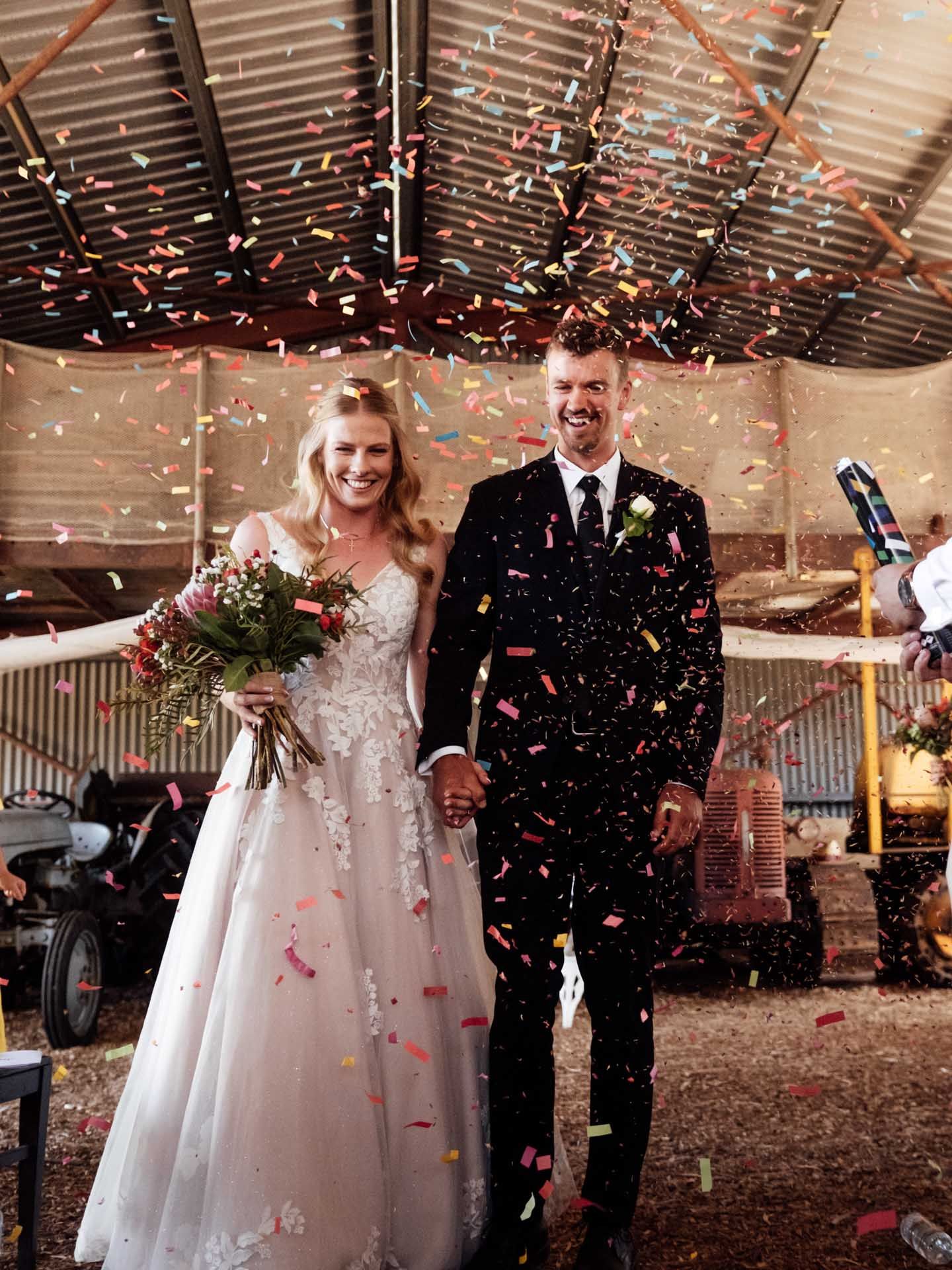 Bride and groom walk down the isle with confetti  in the Adelaide Hills, photographed by Barossa Valley wedding photographer Matt Webster.